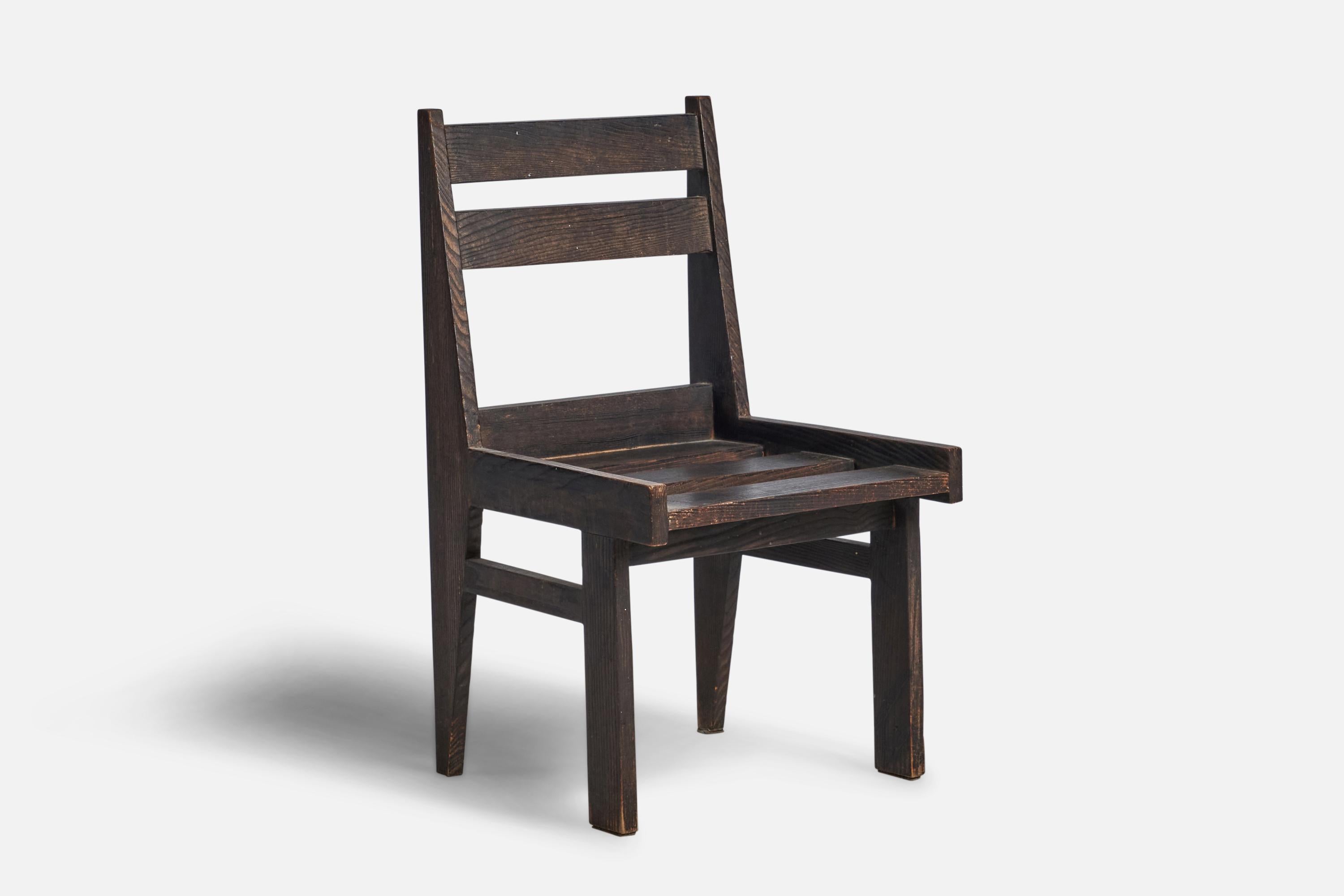 A dark-stained oak side chair designed and produced in the Netherlands, c. 1940s.

14.75” seat height