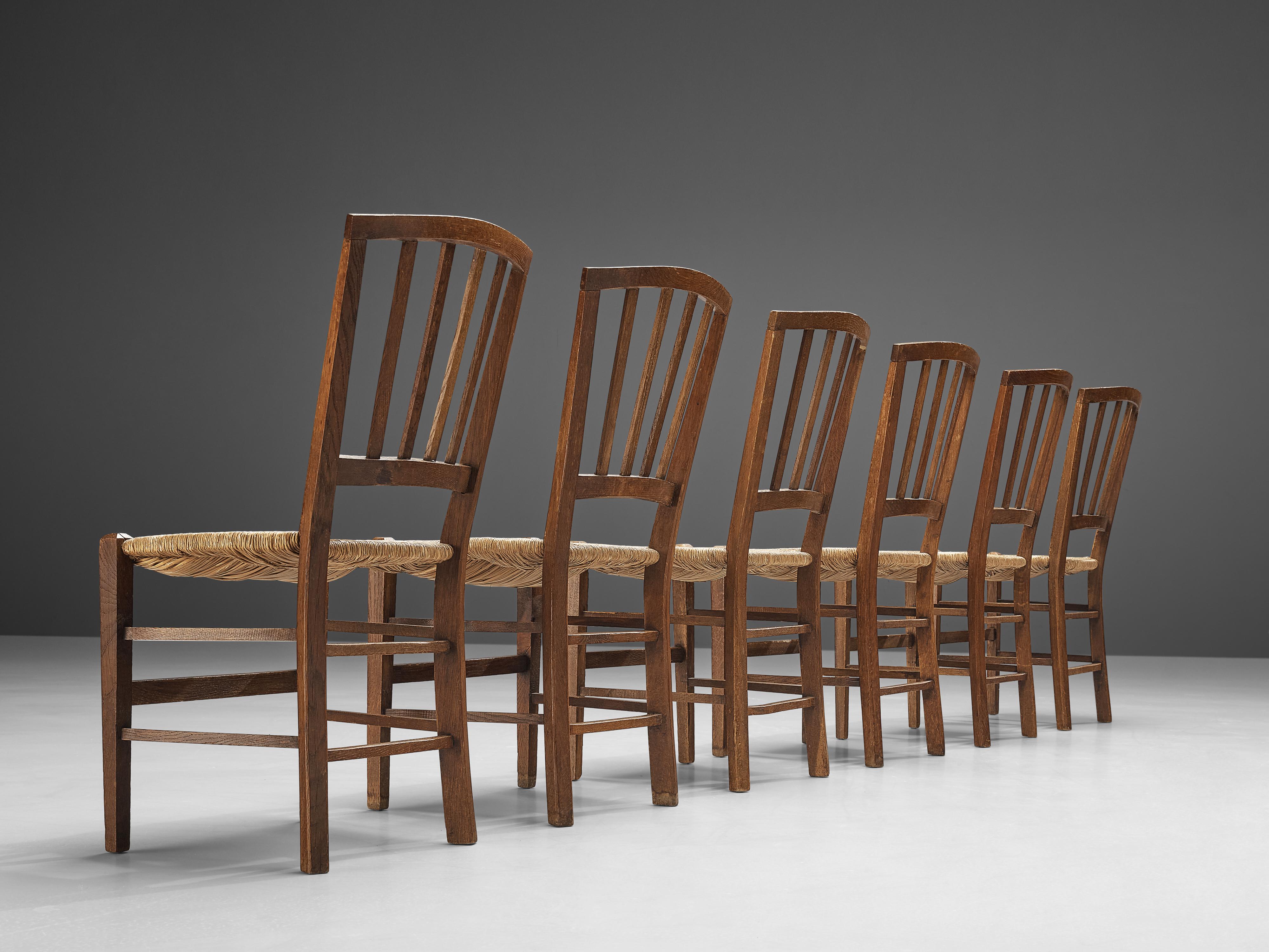 Dining chairs, oak, paper cord, The Netherlands, 1960s

Set of Dutch dining chairs in oak and paper cord, made in the 1960s. These dining chairs feature a geometric backrest that slightly curves to provide comfort for the user. Vertical slats