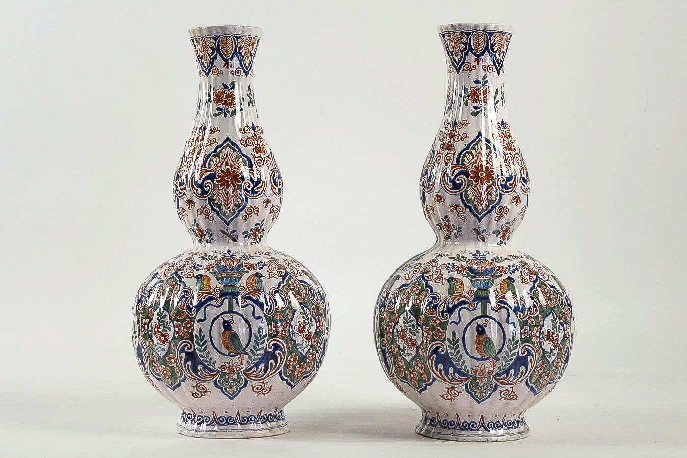 We are pleased to present you, a beautiful and rare Delft faience polychrome pair of gourd-shaped vases, decorated with hand-painted stylized flowers, Lotus flowers end birds, opaque tin glazes that made in Delft 18th century.

Our pair of vases