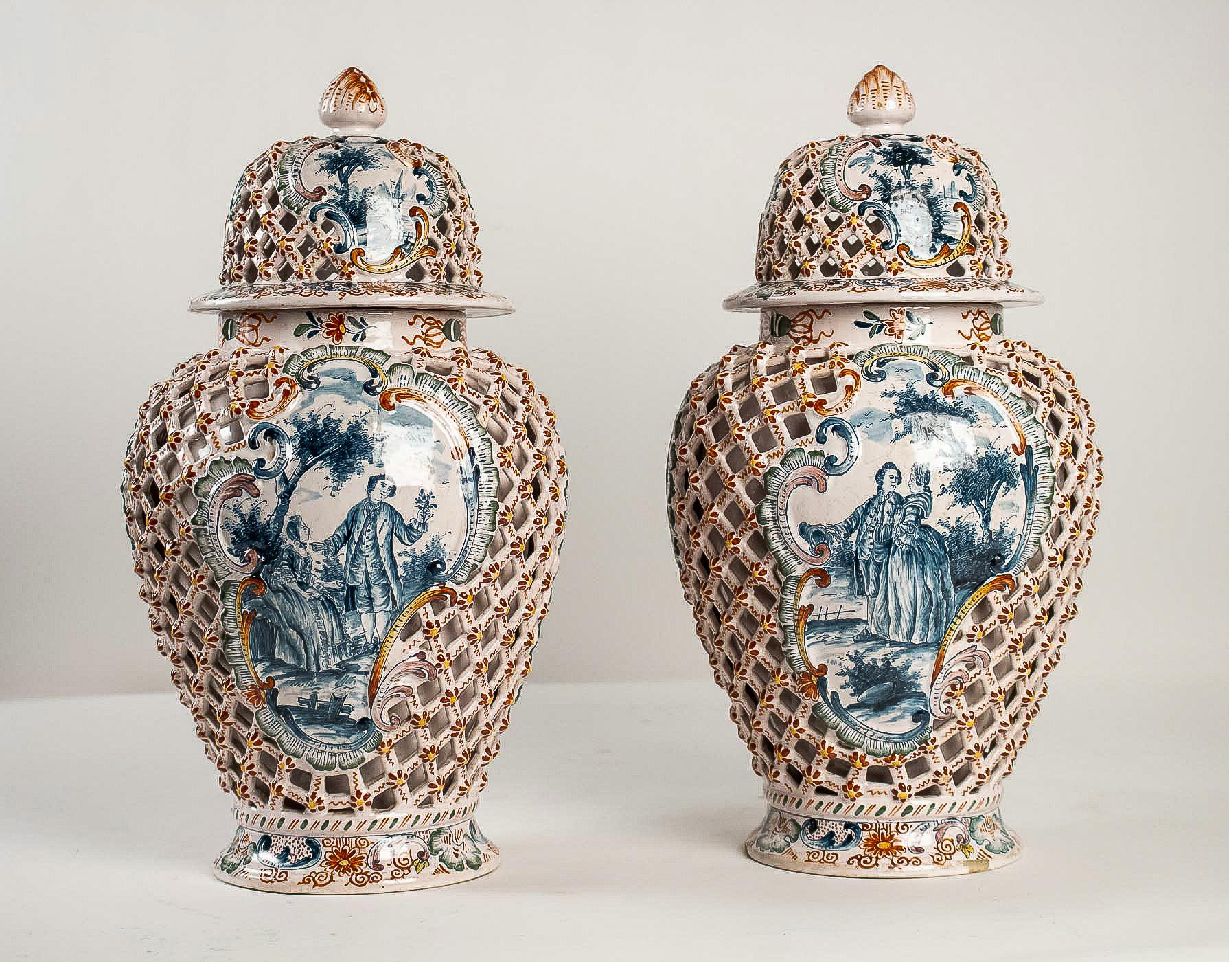 Dutch early-19th century, polychrome delft faience pair of vases, circa 1810-1818

A beautiful and rare delft faience polychrome pair of vases, decorated with a courteous and farmer scenes in the center and in Rocaille style in red, blue et gold