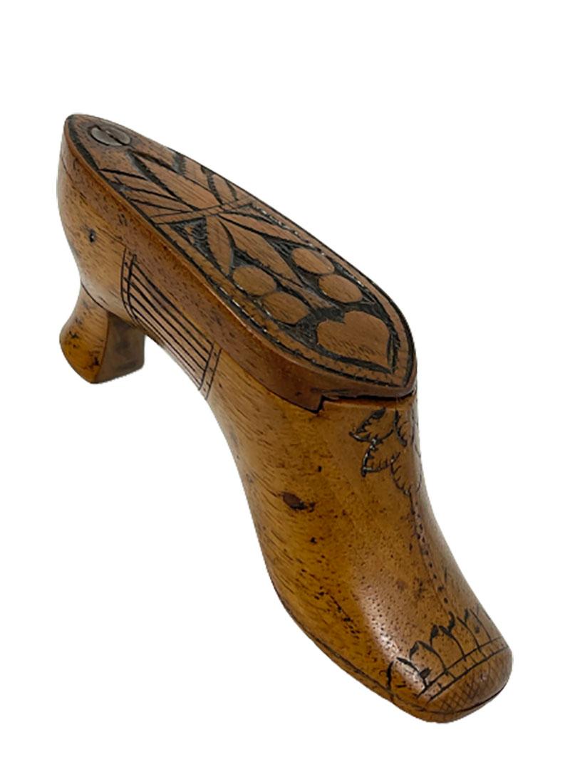 Dutch early 19th century wooden shoe shaped snuff box

An early 19th century wooden hand carved snuff box
The lid slides open and closed over the top.

Measures 4 cm high, 12 cm long and the depth is 3.2 cm 
The weight is 30 gram.