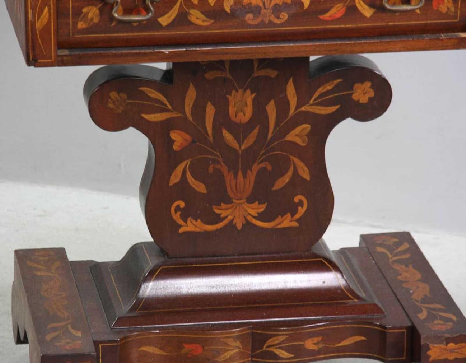 Dutch Empire marquetry stand in mahogany and fruitwood, circa 1840. Wonderful foliate inlay with bordered edges and a butterfly on the top of the piece. Opens with original brass bail handle pulls. Stand sits atop four caster wheels which move