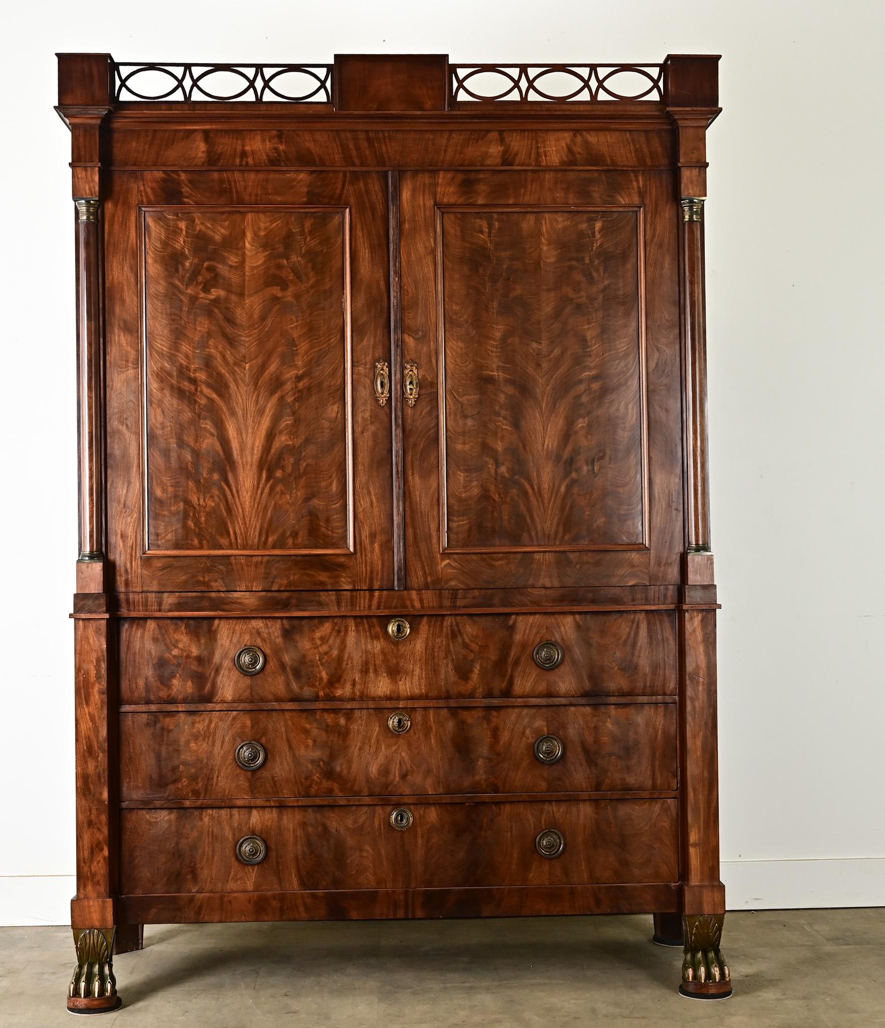 This outstanding Dutch linen press is a testament to the ambitions of the cabinetmaker. Bookmatched mahogany animates the outside surfaces, framed and enriched by the columnar pilasters referencing Neoclassical architecture. Prominent claw feet in