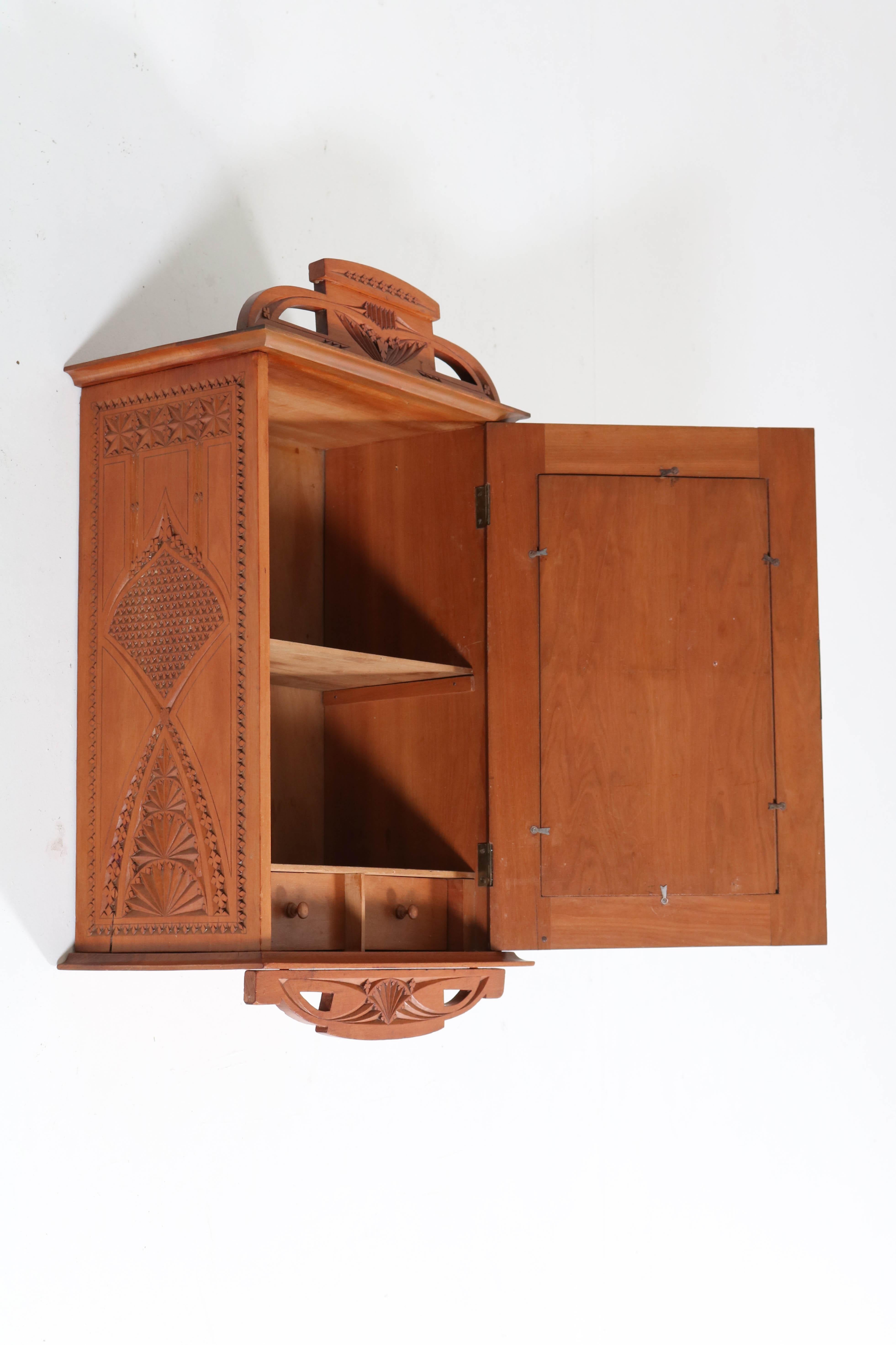 Offered by Amsterdam Modernism:
Stunning and rare Art Nouveau wall cabinet.
Fruitwood with nice kerfschnitt carving.
Striking Dutch design from the 1900s.
In good original condition with minor wear consistent with age and use,
preserving a beautiful
