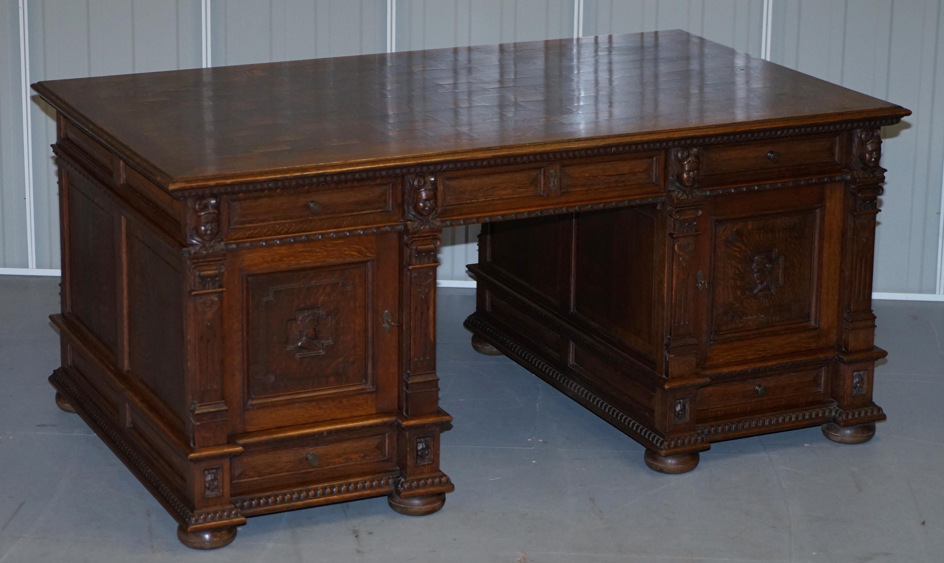 We are delighted to offer for sale this stunning hand carved solid oak Dutch twin pedestal double sided partner desk and matching original leather armchair circa 1940s

This set was hand made by a master craftsman in Bruges Belgium for a very