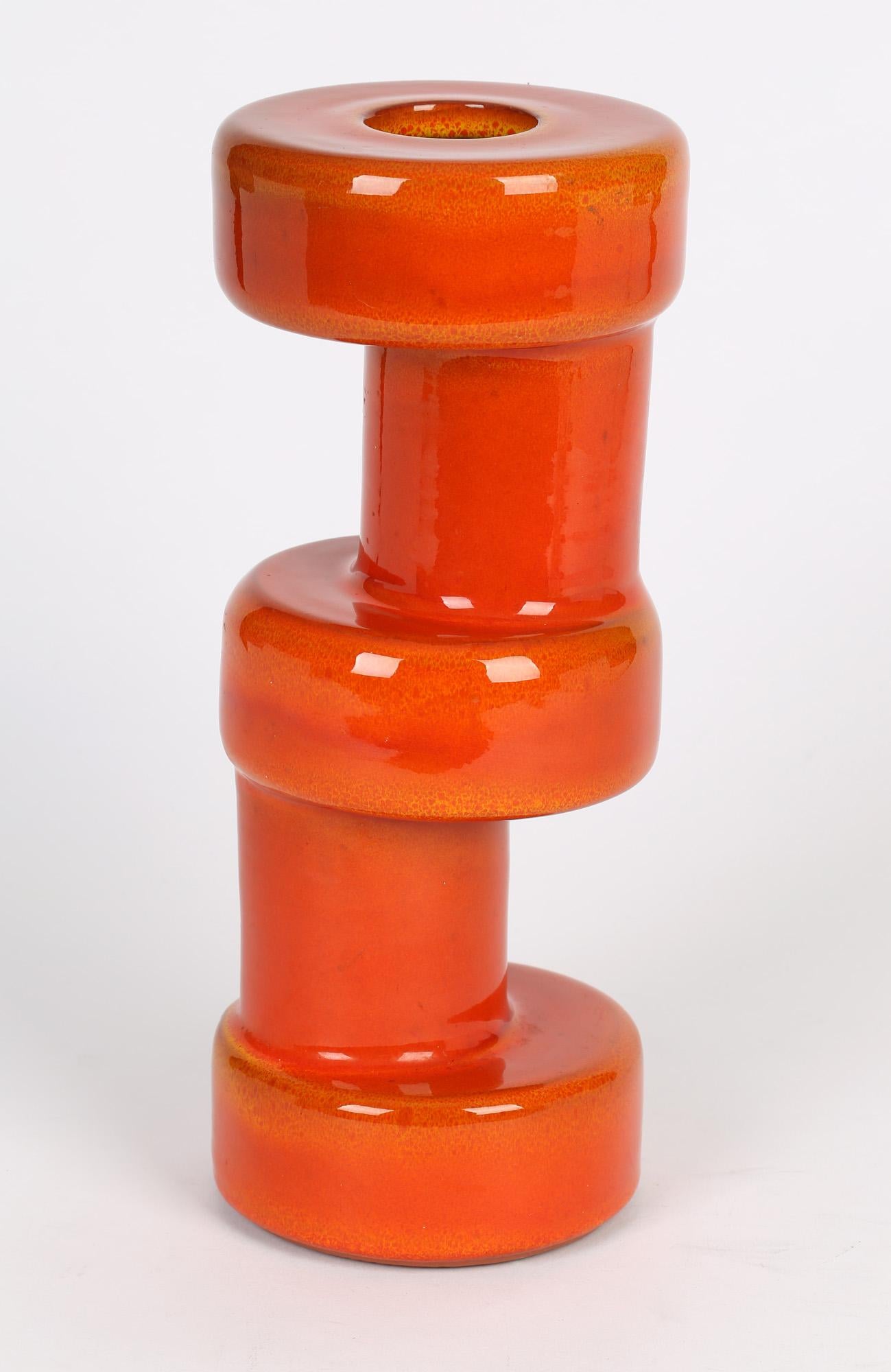 An unusual and striking mid-century Dutch Brutalist orange glazed art pottery vase possibly by Jaap Ravelli (1916-2011) and dating from around 1960. The vase is heavily made in terracotta clay and is made in three rounded cylindrical sections