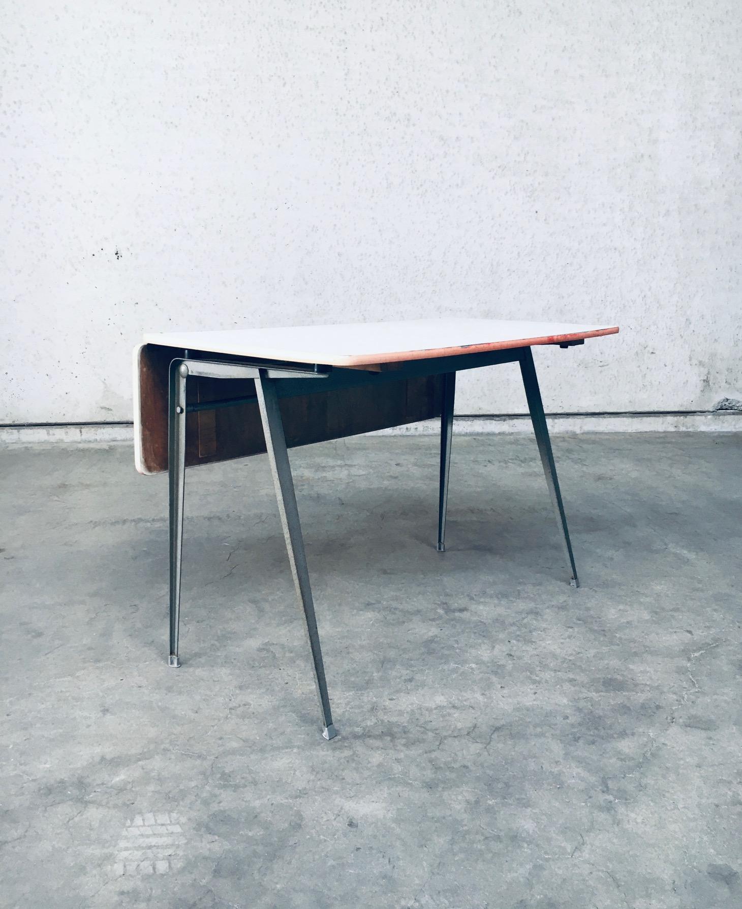 Vintage Midcentury Dutch Industrial Design Desk by Wim Rietveld and Friso Kramer for Ahrend De Cirkel. Made in the Netherlands, late 1950's, early 1960's. A RARE and hard to find design desk. Probably used in a school, hence the signs on the