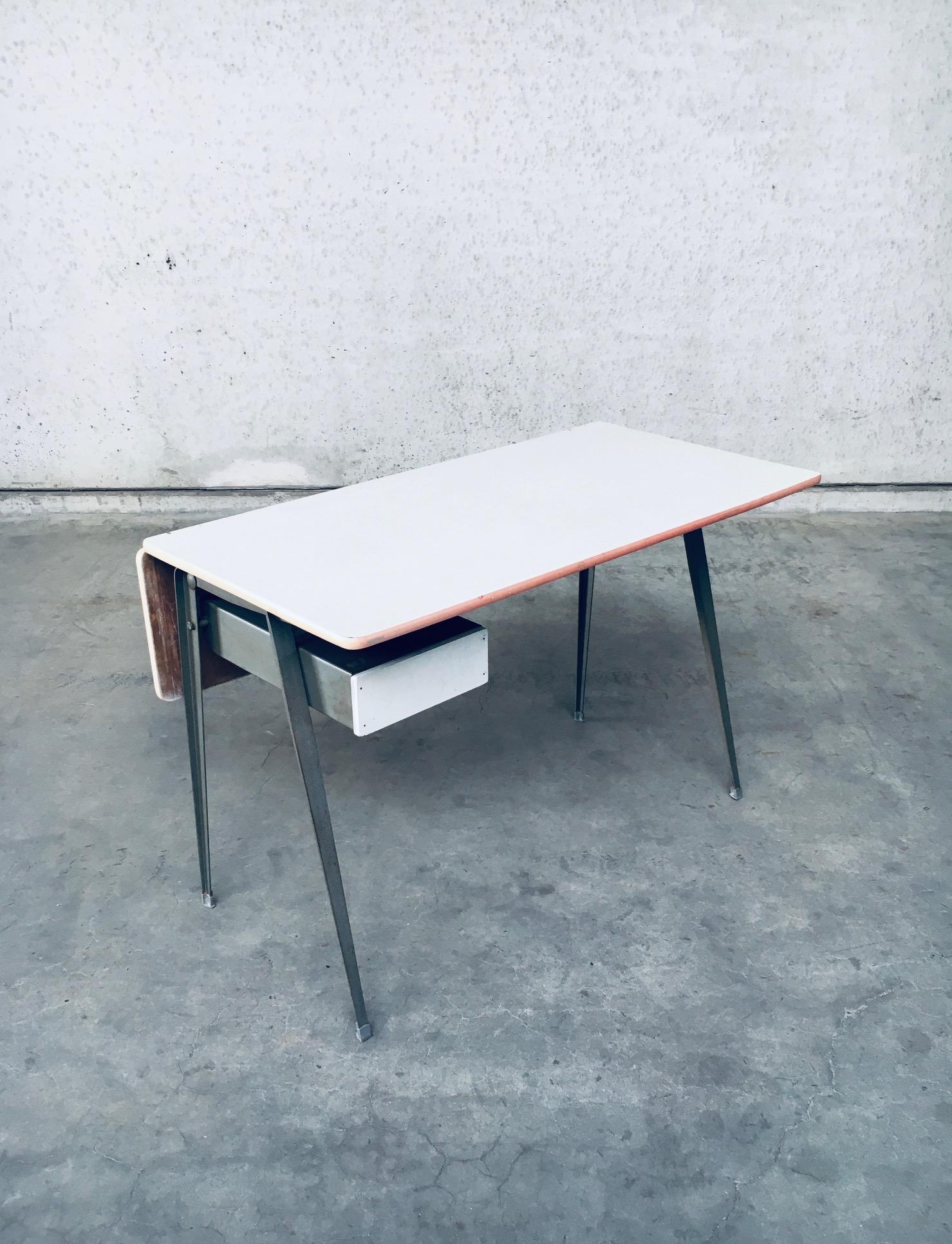 Vintage Midcentury Dutch Industrial Design Desk by Wim Rietveld and Friso Kramer for Ahrend De Cirkel. Made in the Netherlands, late 1950's, early 1960's. A RARE and hard to find design desk. Probably used in a school, hence the signs on the