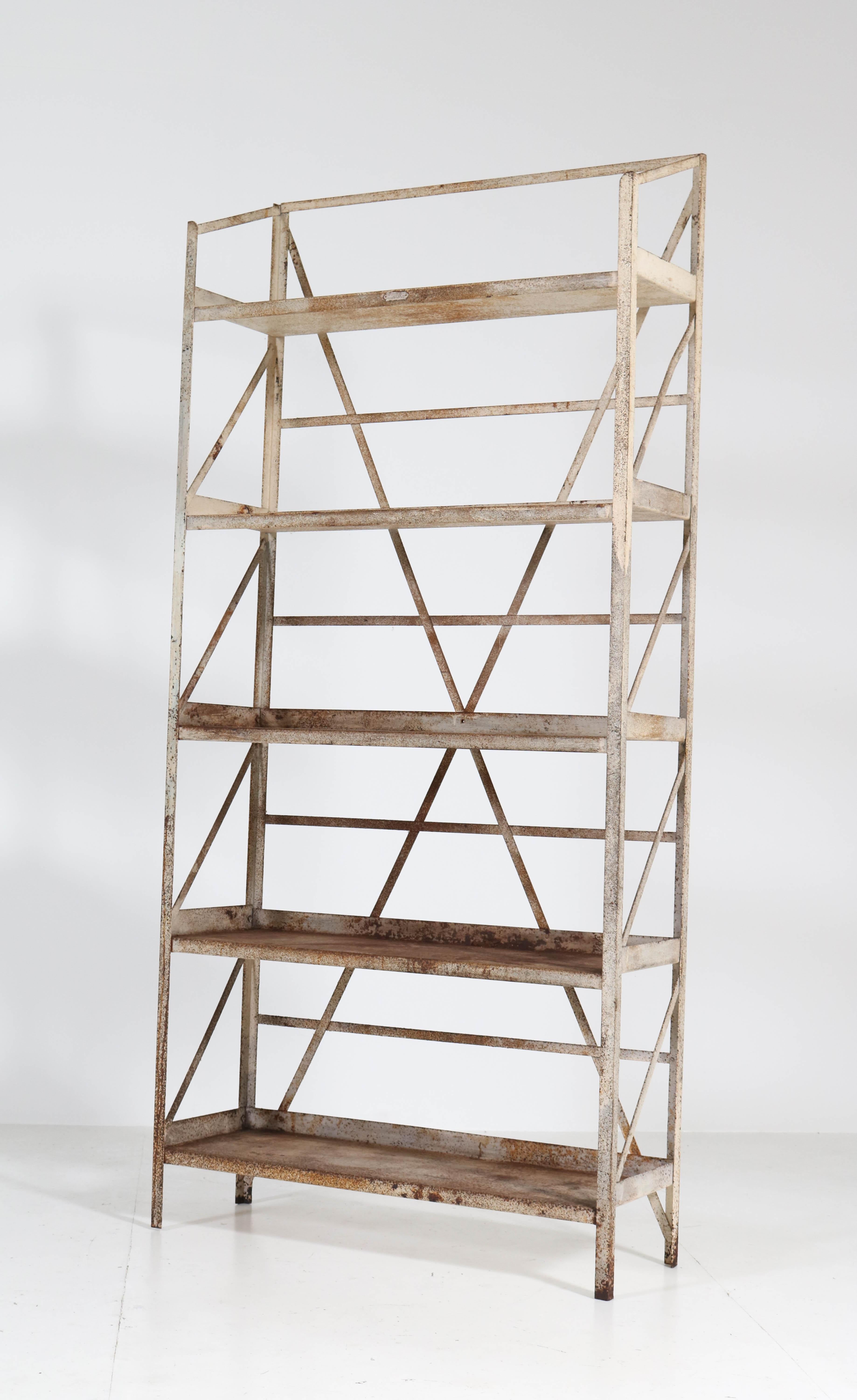 Stunning and rare Industrial shelving unit or storage rack.
Design by Fa. Koller & Van Os, Amsterdam.
Striking Dutch design from the 1930s.
Welded-steel frame with a nice patina of oxidation and other wear-and-tear from
years of use.
Marked
