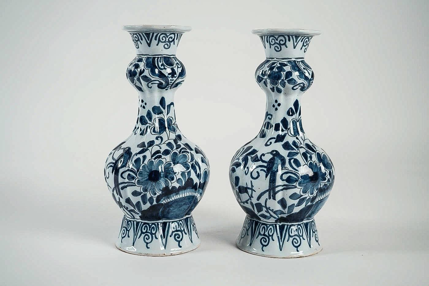 We are pleased to present you, a beautiful and rare Delft faience blue and withe pair of gourd-shaped vases, decorated with hand-painted stylized flowers, Lotus flowers end birds, opaque tin glazes that made in Delft 17th or 18th century.

Our