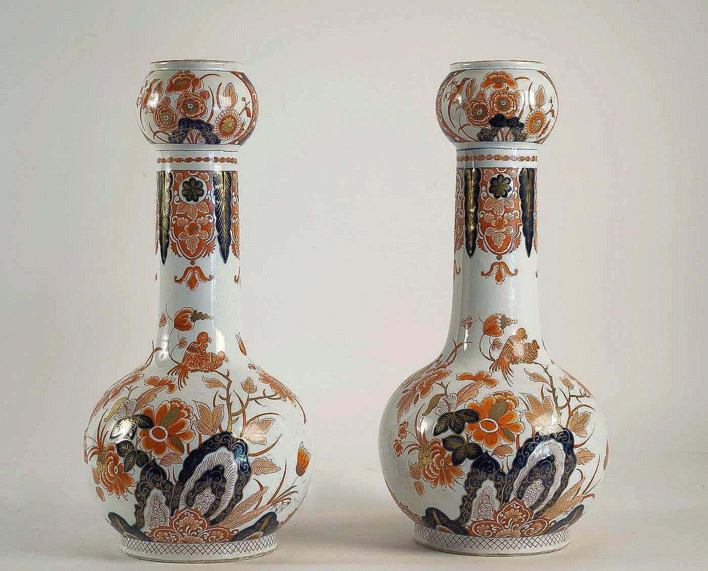 A beautiful and rare Delft faience polychrome pair of gourd-shaped vases, decorated in Imari style in red, blue et gold colors with hand-painted stylized flowers, Lotus flowers end birds, opaque tin glazes that made in Delft 18th century.

Our pair