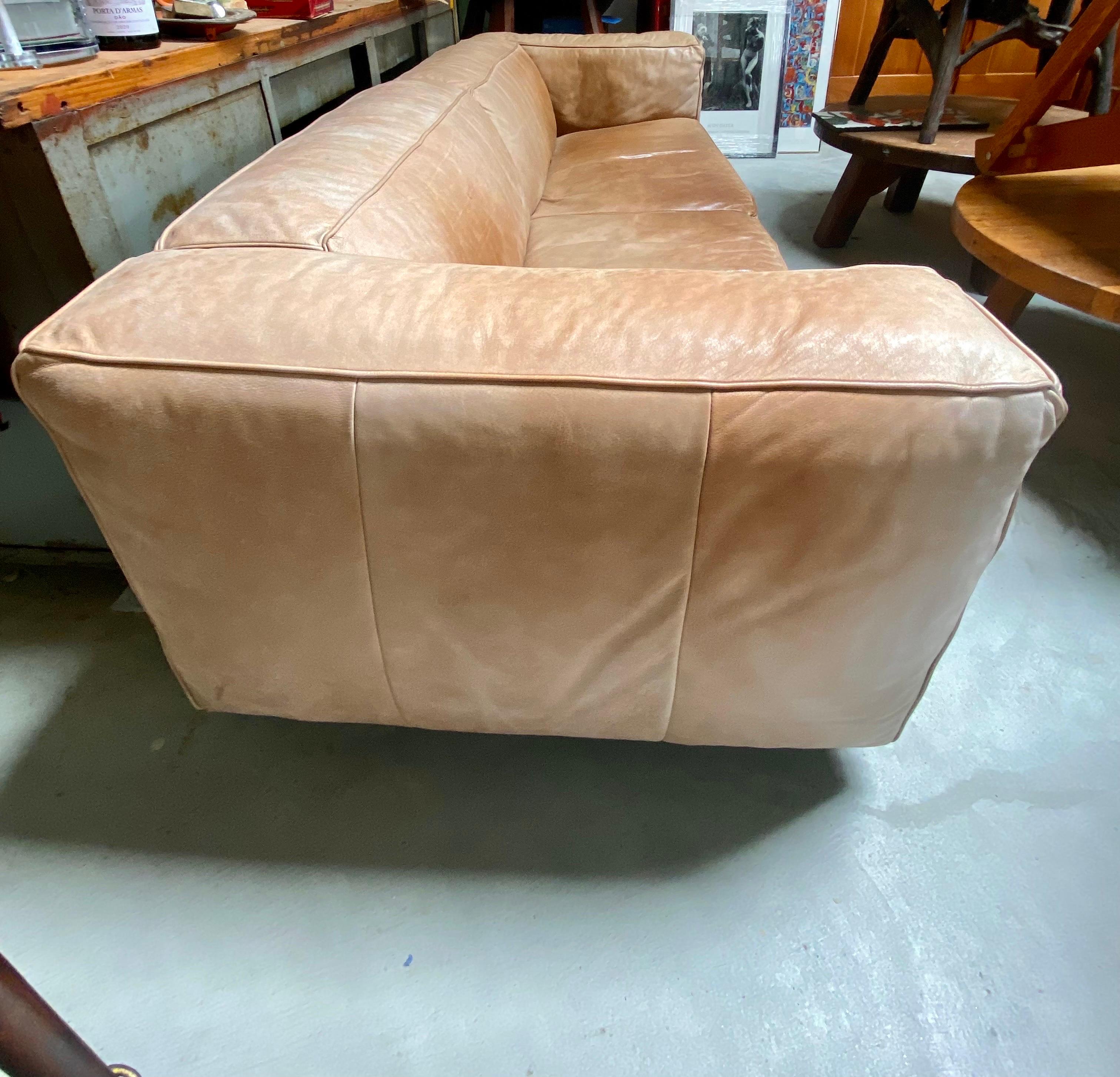 Large vintage leather sofa, the Netherlands, circa 1970s features patina with metal legs. This leather sofa is in good overall condition. 
Dimensions: 96