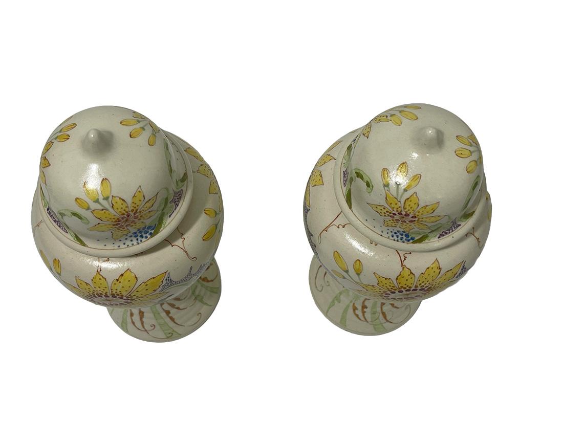 2 lidded vases by Ivora Gouda, Model 170 ca 1915

2 lidded vases earthenware with floral hand-painted decoration in Art Nouveau style, made by pottery factory Ivora Gouda (P. van der Want Gzn ). Mat beige , cream  uses with colorful Art Nouveau