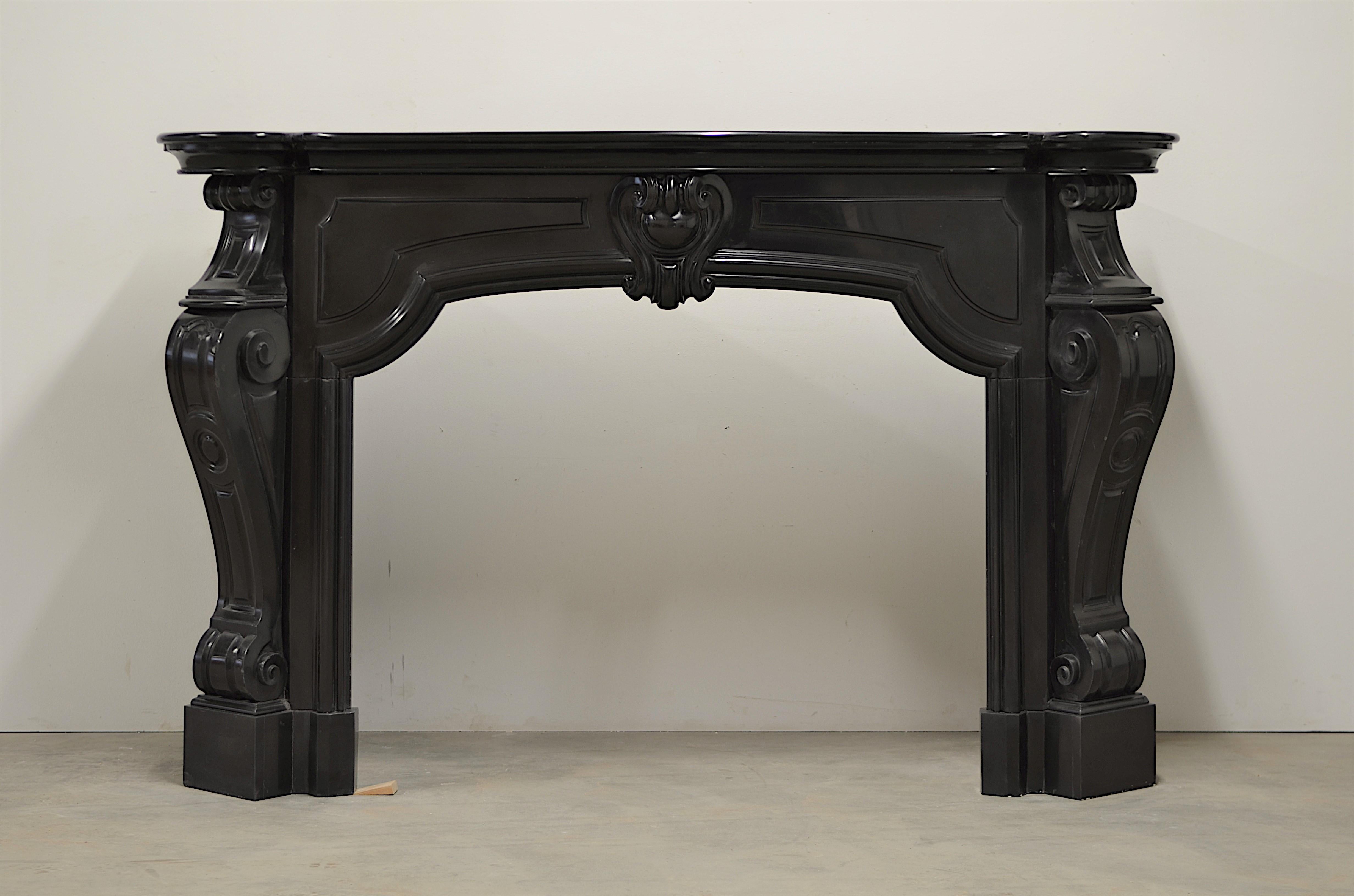 Late 19th century Dutch Louis XV fireplace executed in superb Belgian black marble.
The opulence and size of this monumental mantel are as impressive as the details and craftsmanship that went into making this.

The strong lines and powerful