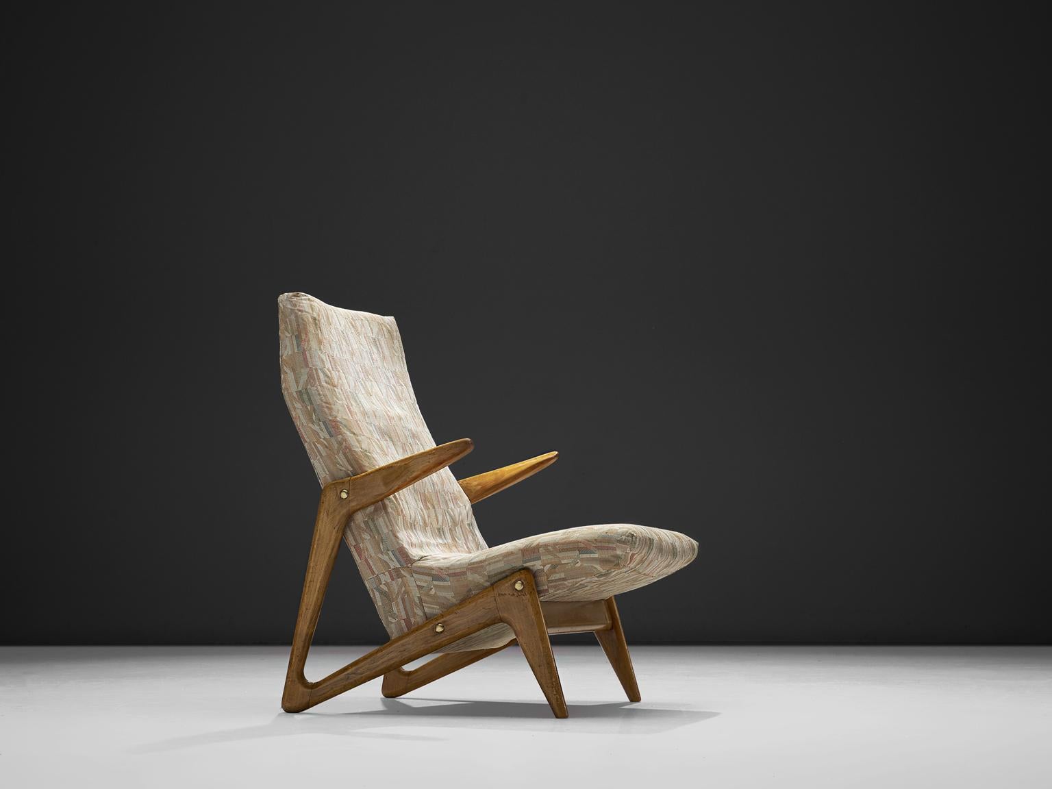 Lounge chair, fabric and walnut, Belgium, 1940s.

This well-detailed easy chair features an outstanding walnut frame in which the legs and armrest form one line. The piece is attributed to Alfred Hendrickx for belform. The chair has a sculptural