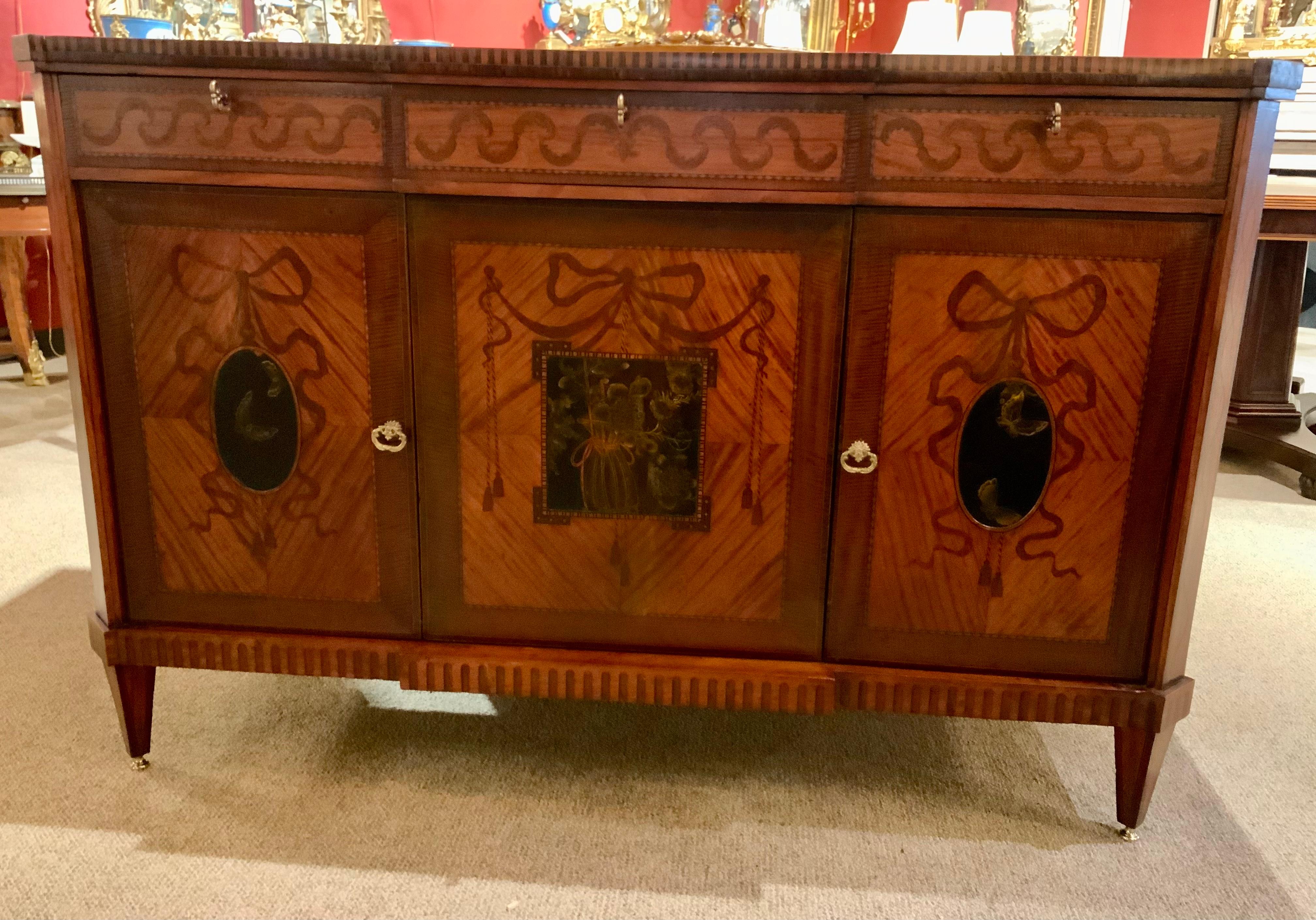 This unique piece is 19 th century with a banded, quarter-veneered top
With a full raised edge and canted corners, above a case fitted with three
Drawers over two cupboard doors each door banded and centered
By an ebonized panel in the