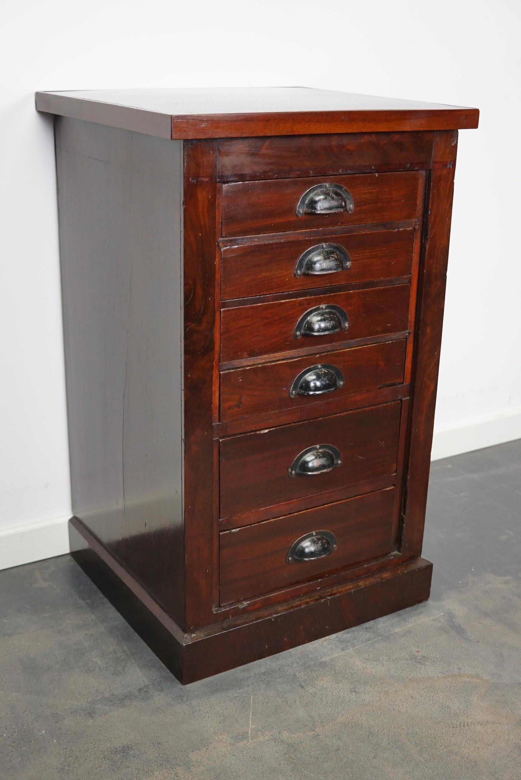This cabinet was designed and made in circa 1930s in the Netherlands. It features 6 drawers and is made of mahogany with black handles. The cabinet is in a good vintage condition. The inside drawer measurements are DWH: 32 x 29 x 6 / 10 cm.