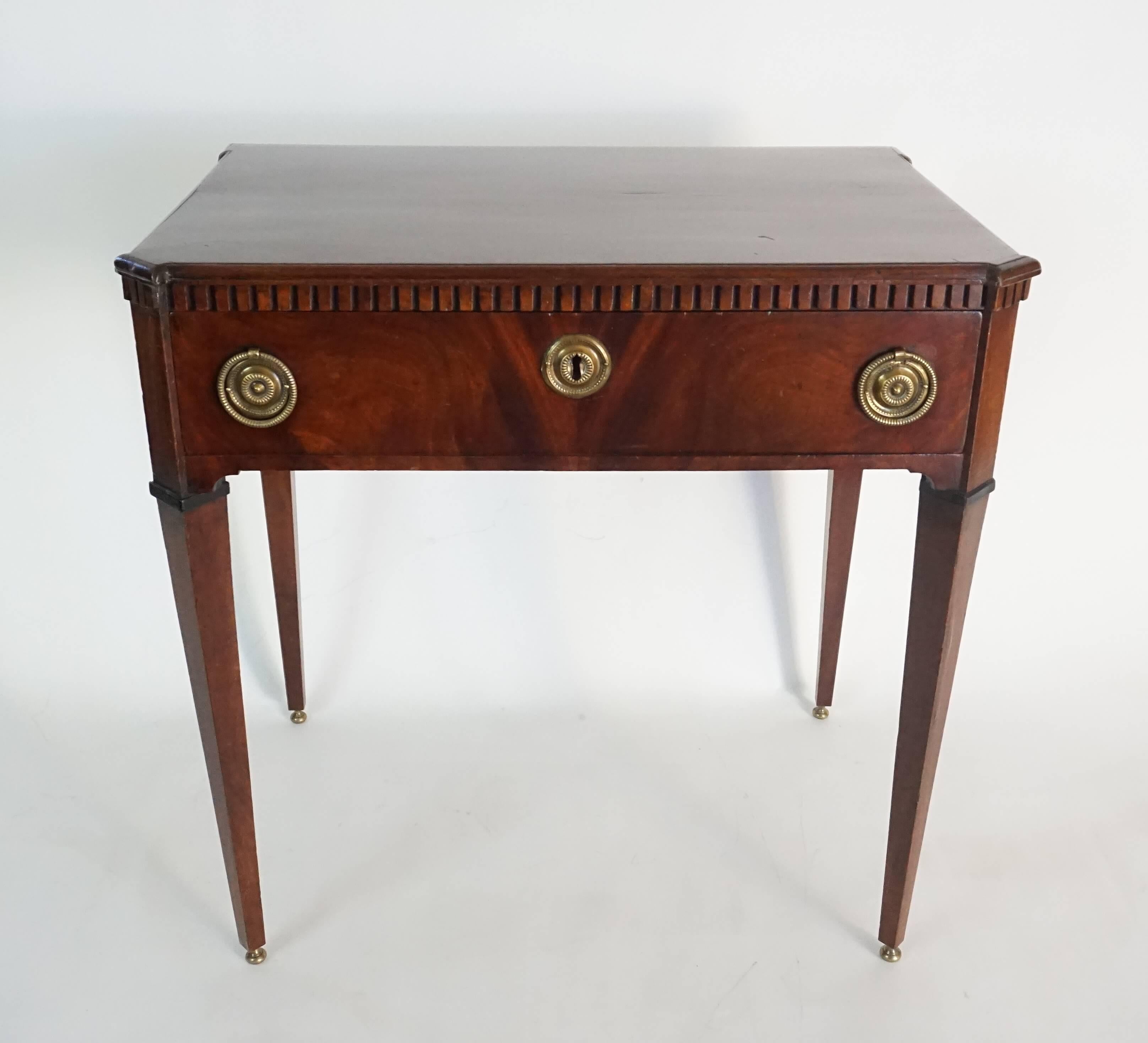 Dutch mahogany side table of rectangular form having dentil moulded cornice above single drawer with original brass hardware on tapered legs ending in brass knob feet, circa 1810.