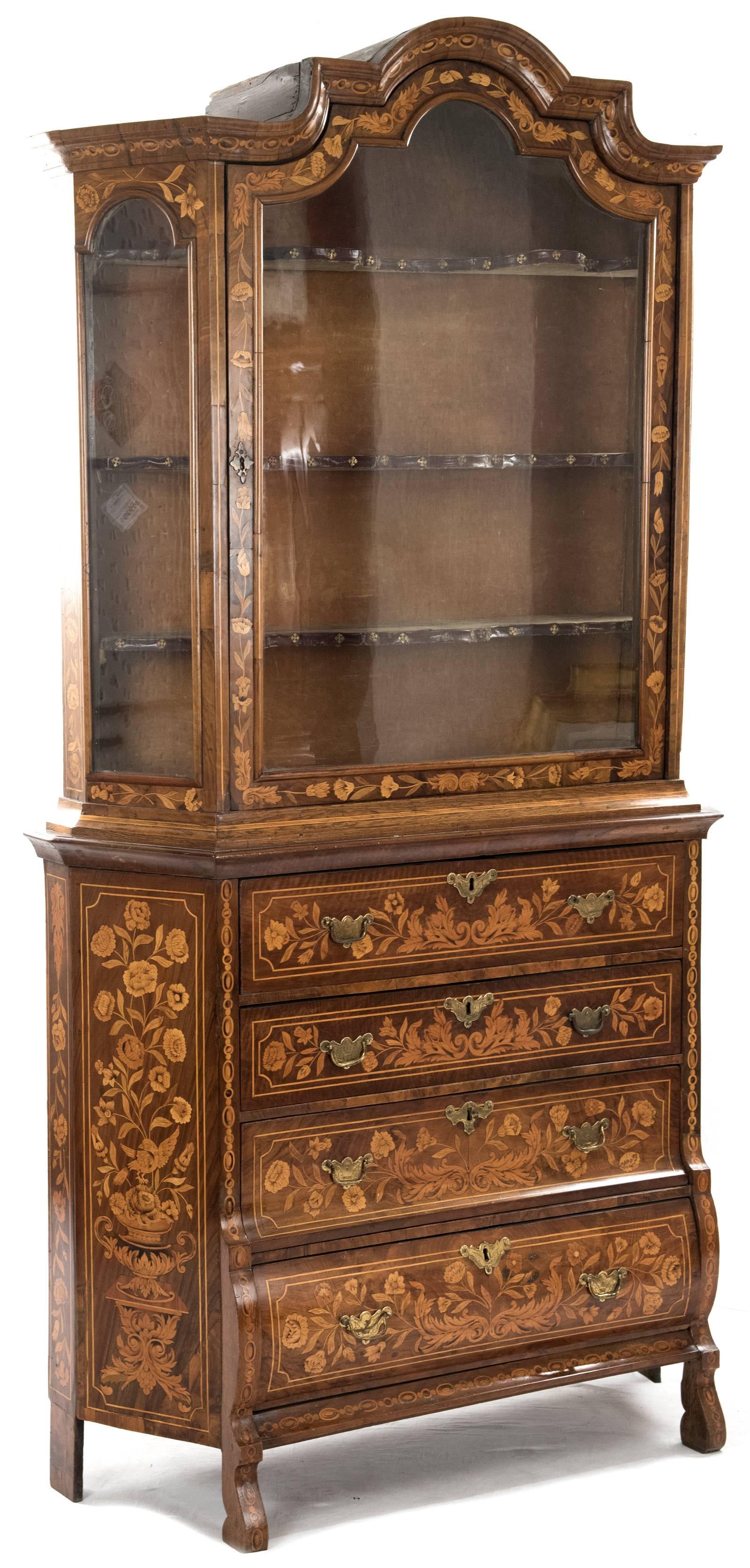 This 19th century Dutch marquetry inlaid cabinet has an upper case with a domed stepped cornice over a single glazed door and glazed canted corners, the interior fitted with three shaped shelves with leather-trimmed edges, all raised on a bombe-form