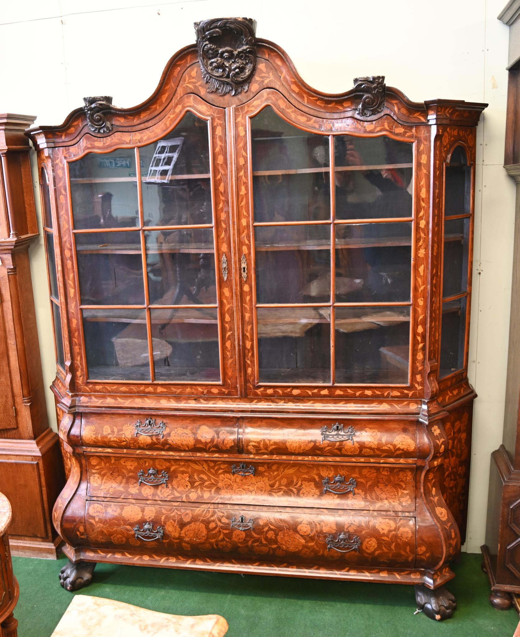 Absolutely stunning Dutch marquetry inlaid large size walnut bookcase
Circa 1820
Classic Dutch marquetry with the intricate floral inlay which is so eye catching
Top half is glass fronted cabinet with lots of shelved storage
Bottom half features the