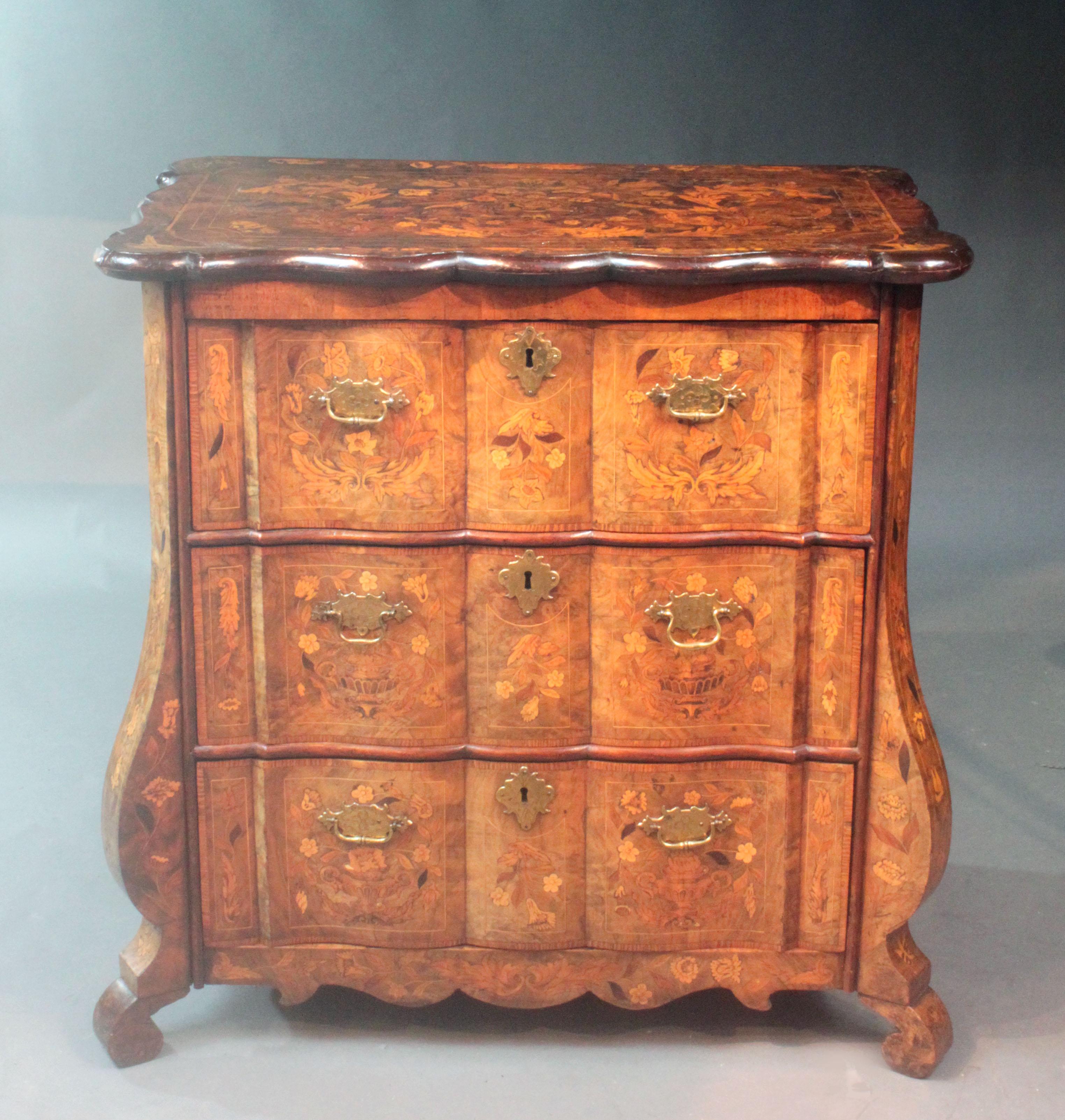 An attractive figured walnut Dutch chest with fine marquetry inlay of birds and flowers; most Dutch chests we have had previously had bombay fronts and often ball and claw feet but I really like this more unusual serpentine shape and top and the