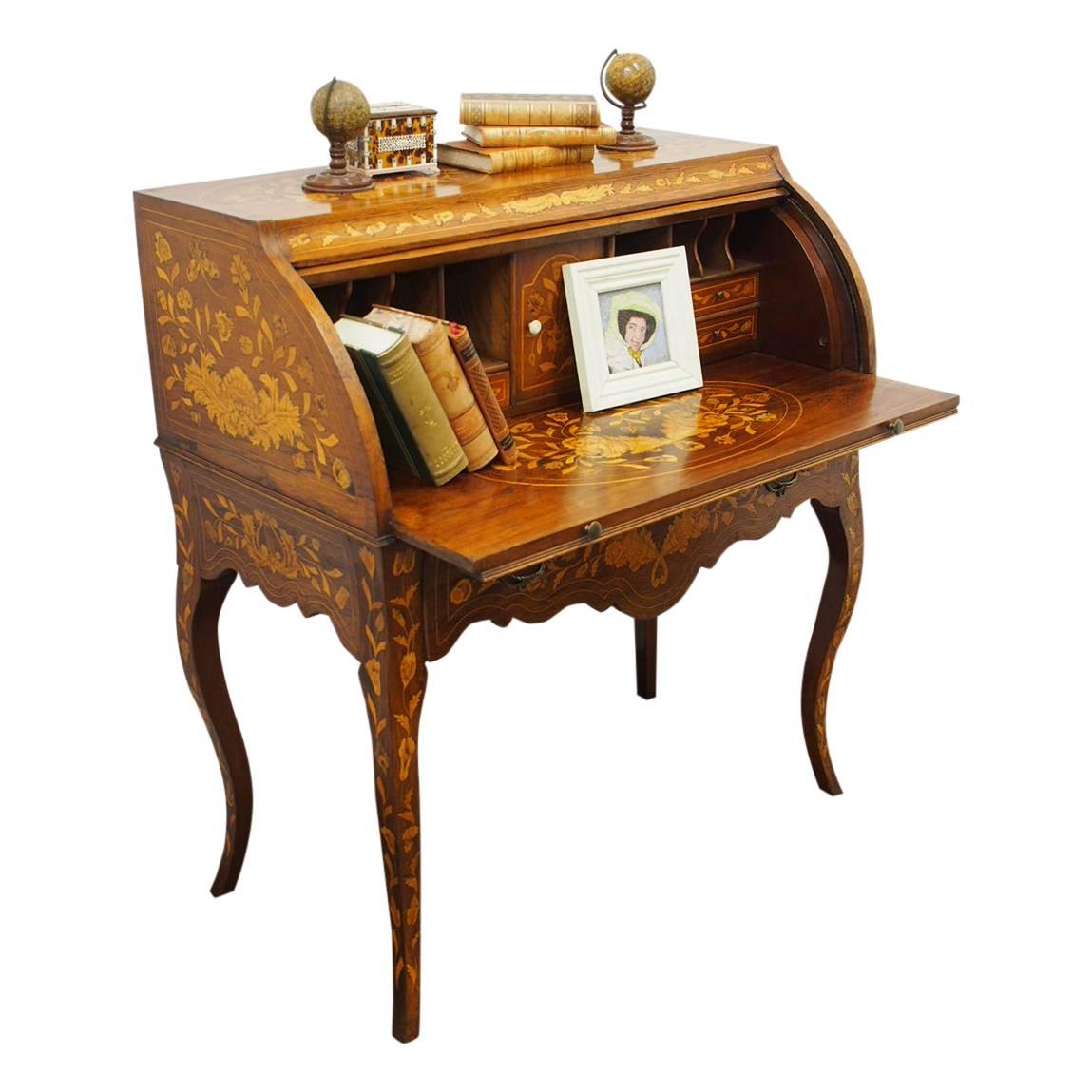Unusual Dutch marquetry cylinder topped desk, circa 1830. The rectangular shaped desk is in a mellow, faded rosewood, and the sides, gables and legs are smothered in Dutch marquetry. The cylinder of the desk has a design of a big bouquet of flowers