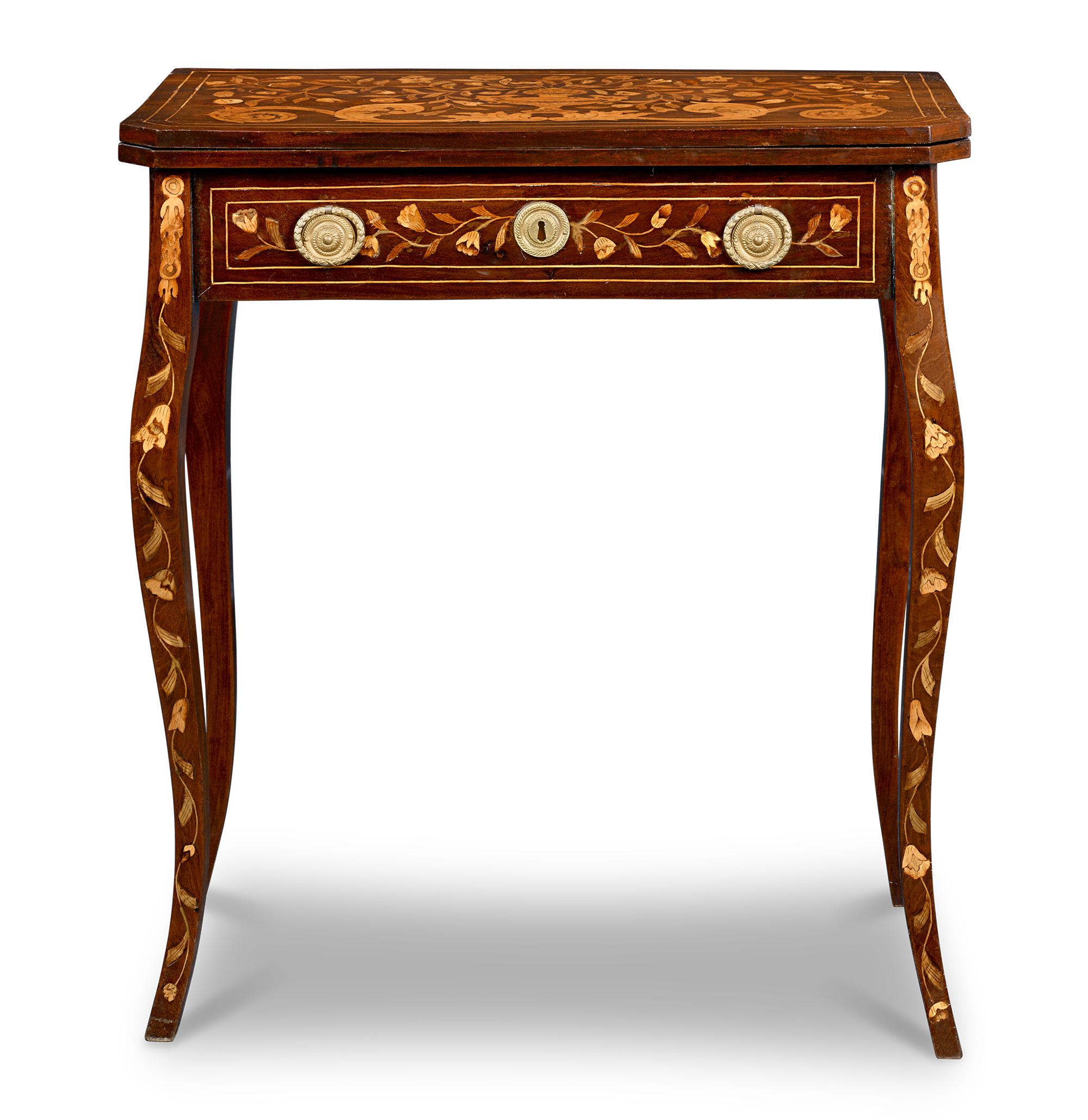 This remarkable 19th-century games table perfectly incorporates beauty and function with tasteful marquetry and a fold-out gaming surface. An elegant example of Dutch craftsmanship and design, the table features intricate marquetry work featuring a