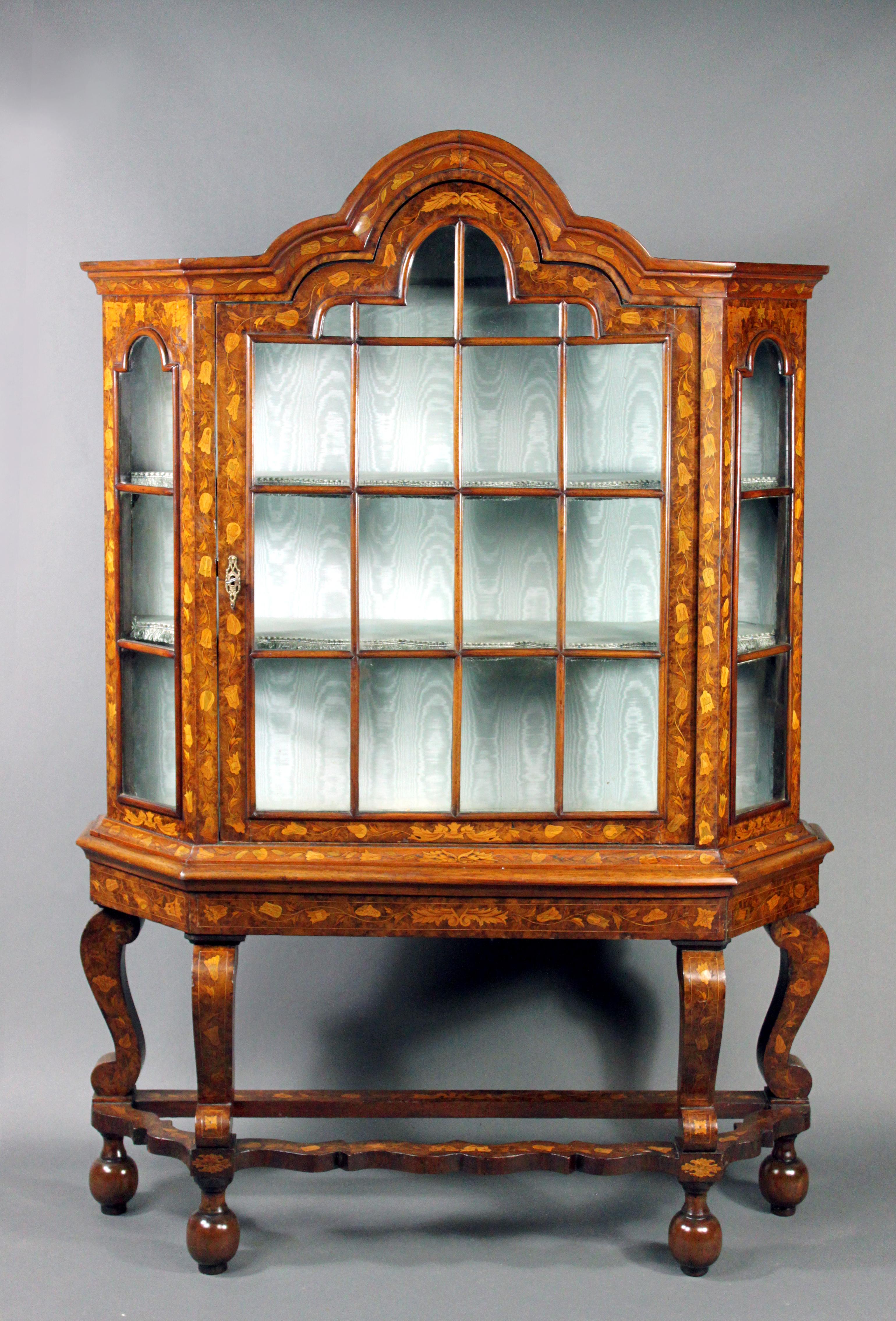 Dutch Marquetry Glazed Cupboard
An attractive 18th/19th century Dutch marquetry glazed cupboard on wavy stretcher stand; the Dutch added the marquetry in the the 19th century as is usual with these pieces; oak backboards and top; shaped graduated