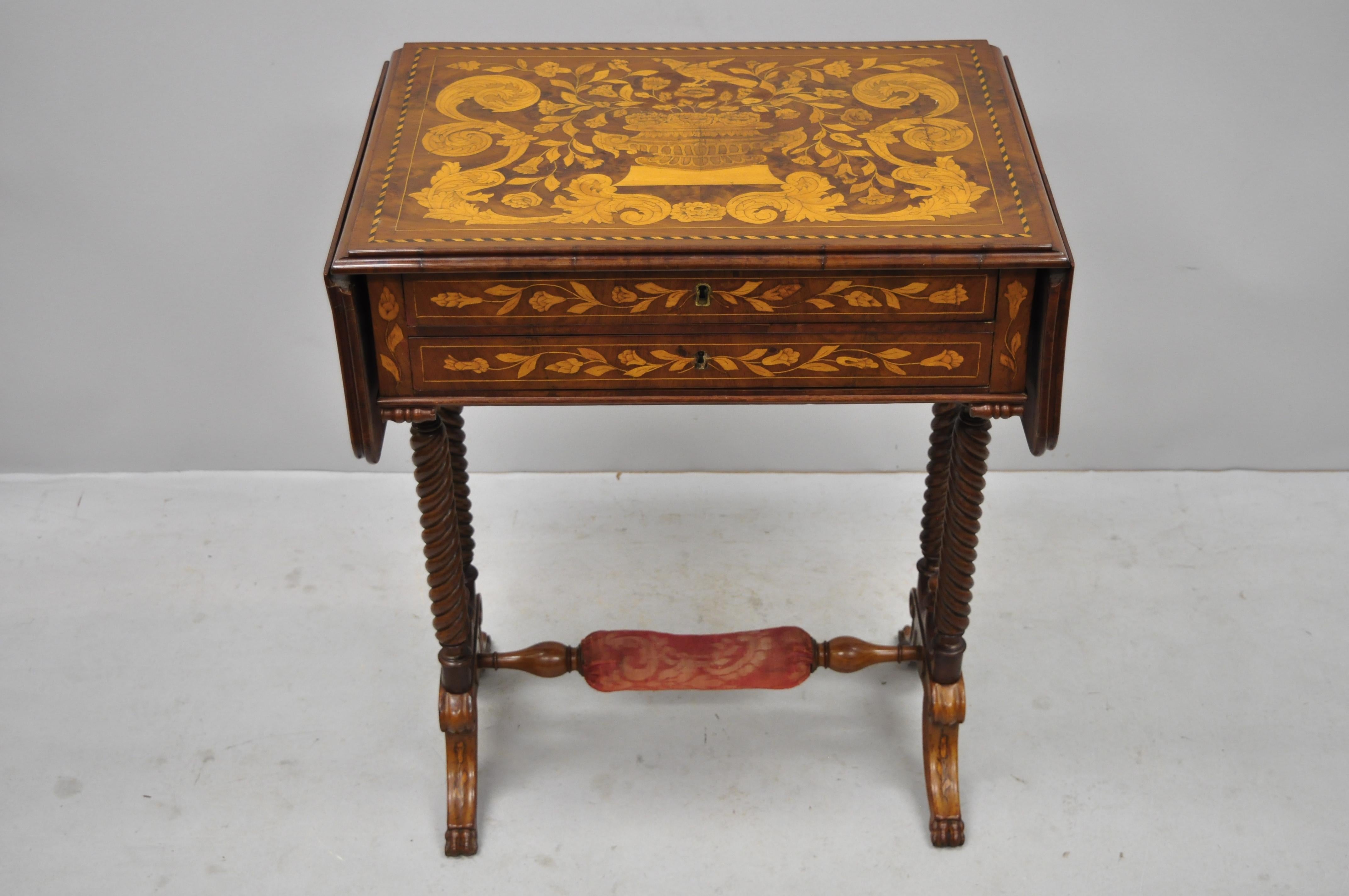 19th century Dutch marquetry inlaid Regency style drop-leaf sewing stand work table. Item features floral marquetry inlay, drop leaf sides, upholstered footrest, nicely carved legs, no key, but unlocked, 2 dovetailed drawers, very nice antique item,