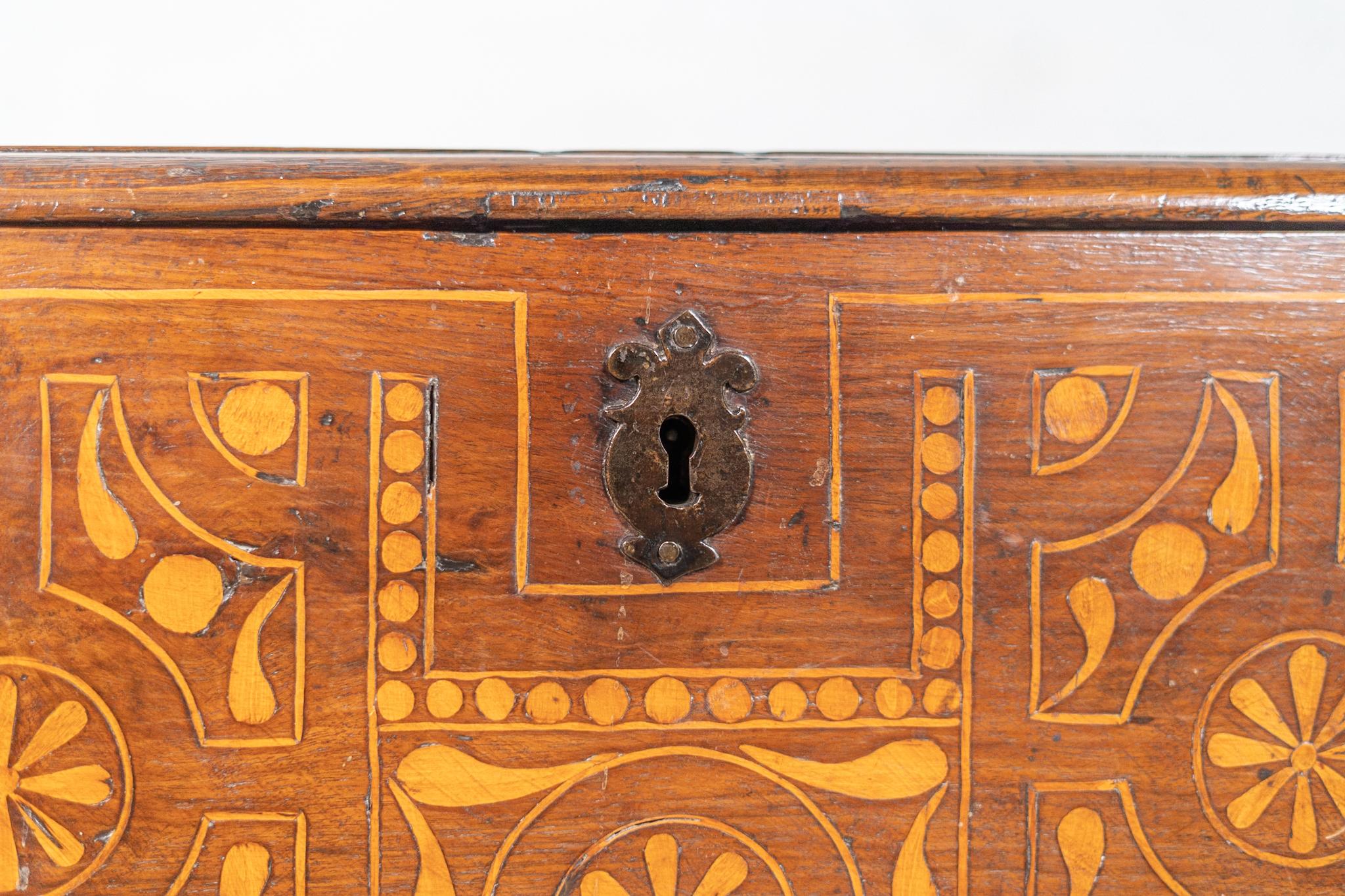 Beautiful dutch marquetry storage chest. With marquetry decorations in geometric shapes in 3 out of 4 sides. The chest stands on round carved legs and includes original iron key hole. 



 