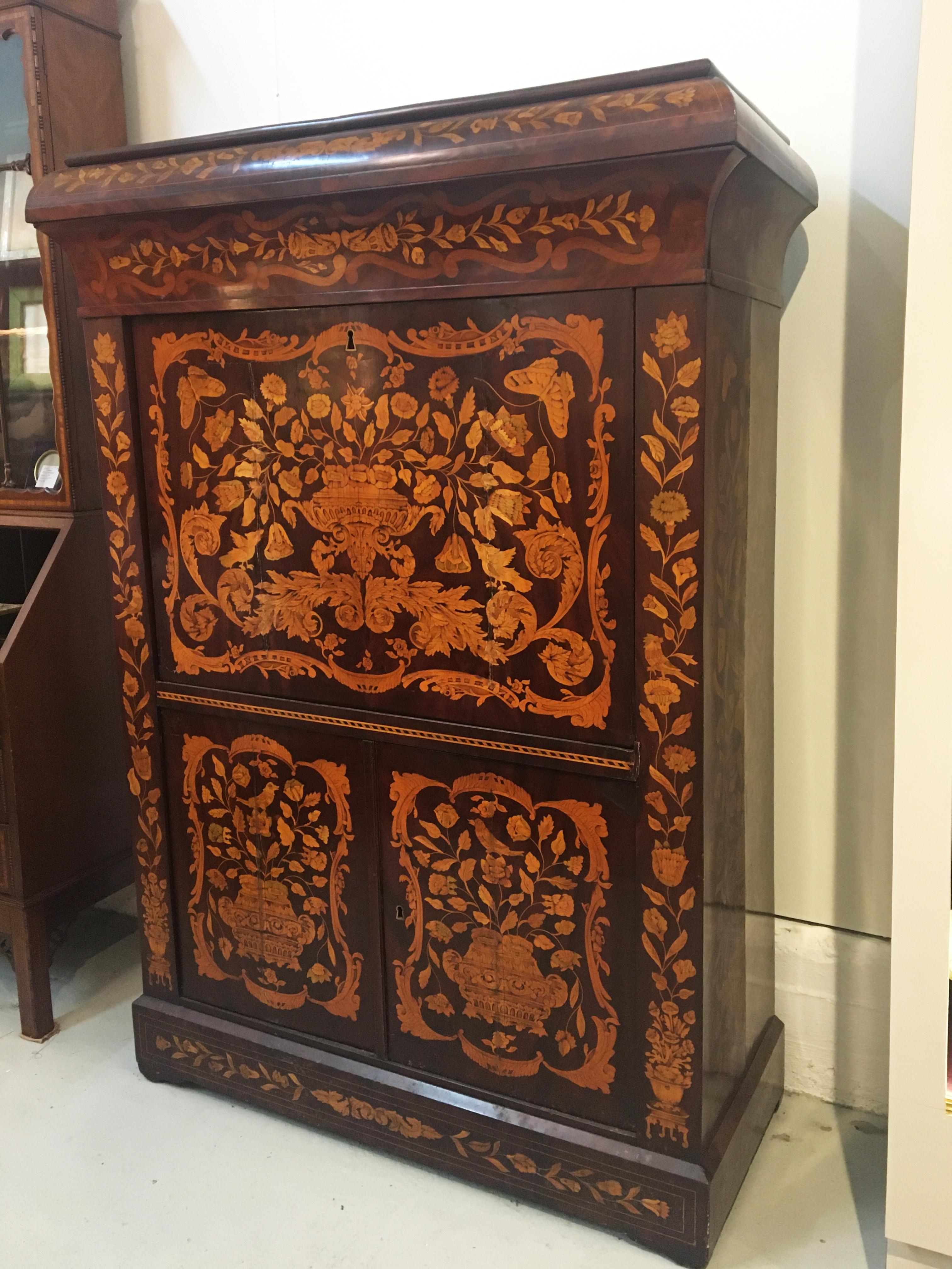 19th century Dutch marquetry secrétaire à Abbatant. With full front desk, one long drawer over beautifully fitted interior with six small drawers flanking a center compartment and over a two-door cabinet.