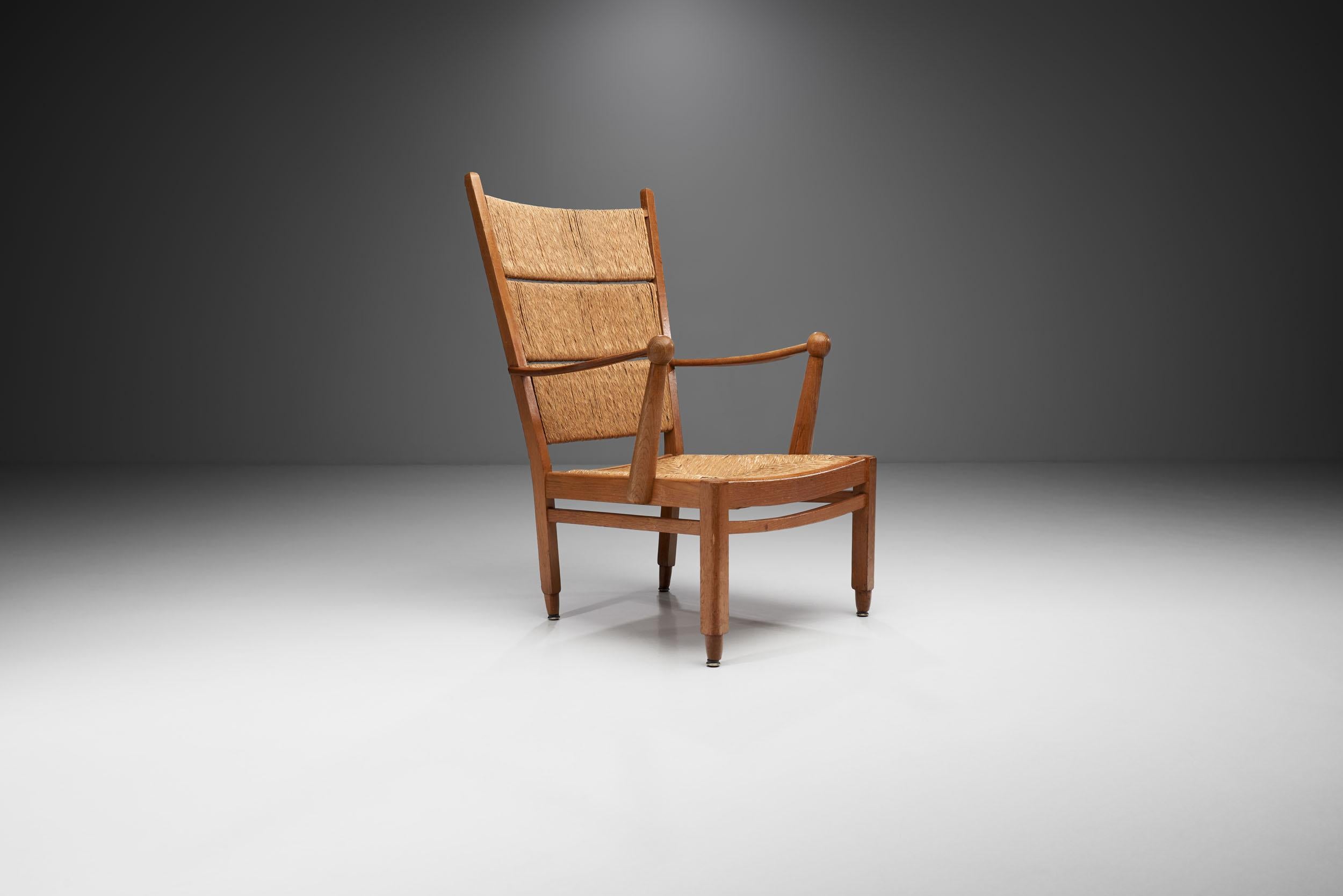 This whimsical armchair in solid oak and straw is commonly attributed to Dutch designer Bas Van Pelt. The construction of this rare early 1940s design is simple at its core, but thanks to the details, it is a playful representation of early Dutch