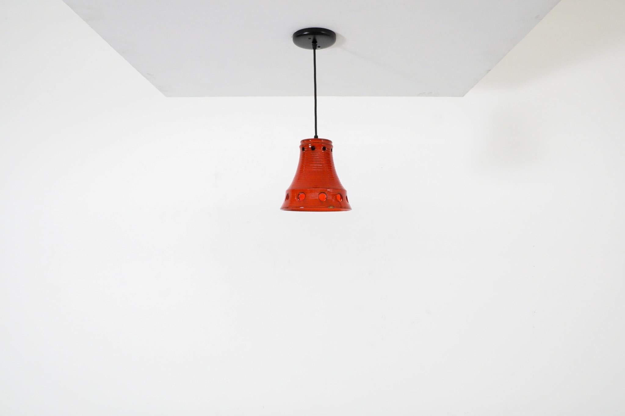 Dutch Mid-Century, Herda manufactured bell-shaped ceramic lights with decorative circular cut-outs. Herda was founded in 1946 and at one time was Holland's largest lighting manufacturer. It employed Jaap Tiepel, Dirk Heyman and Margo van Dijk as a