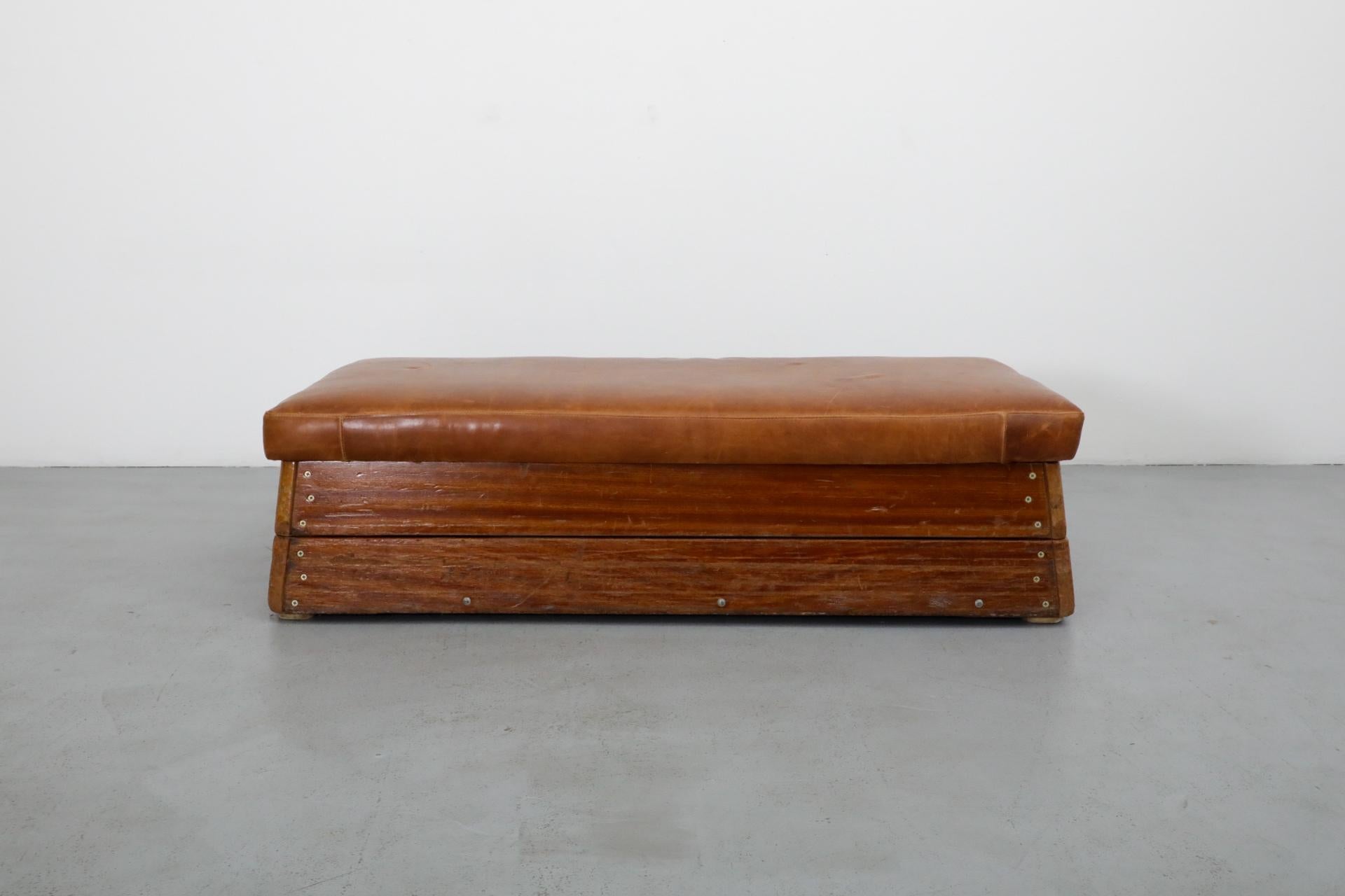 Dutch Mid-Century, multi purpose rolling gymnastics bench by Schelde. This gym piece is made up of individual stacked oak and teak layers make this a multifunctional unit that can be used as an ottoman, bench or even coffee table. Beautiful original
