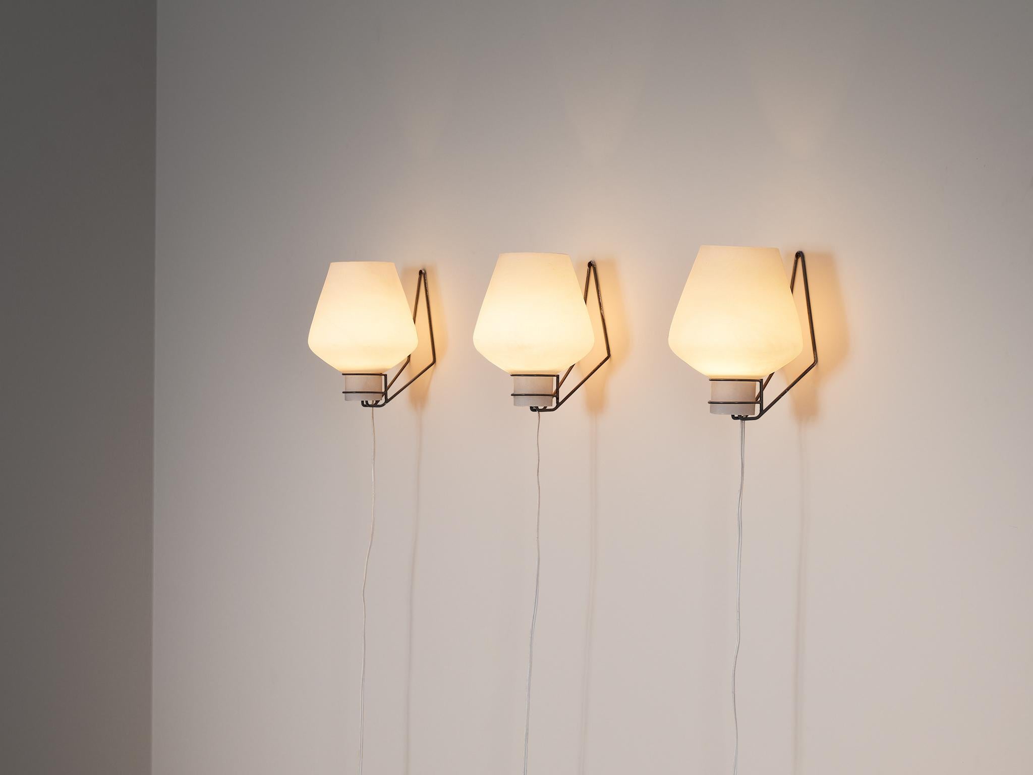 Wall lights, opaline glass, metal, The Netherlands, 1960s

These wall lights have a beautiful and minimalistic appearance. The way this lamp is mounted to the wall makes it very light and modern looking. The base of the opaline shade rests in the