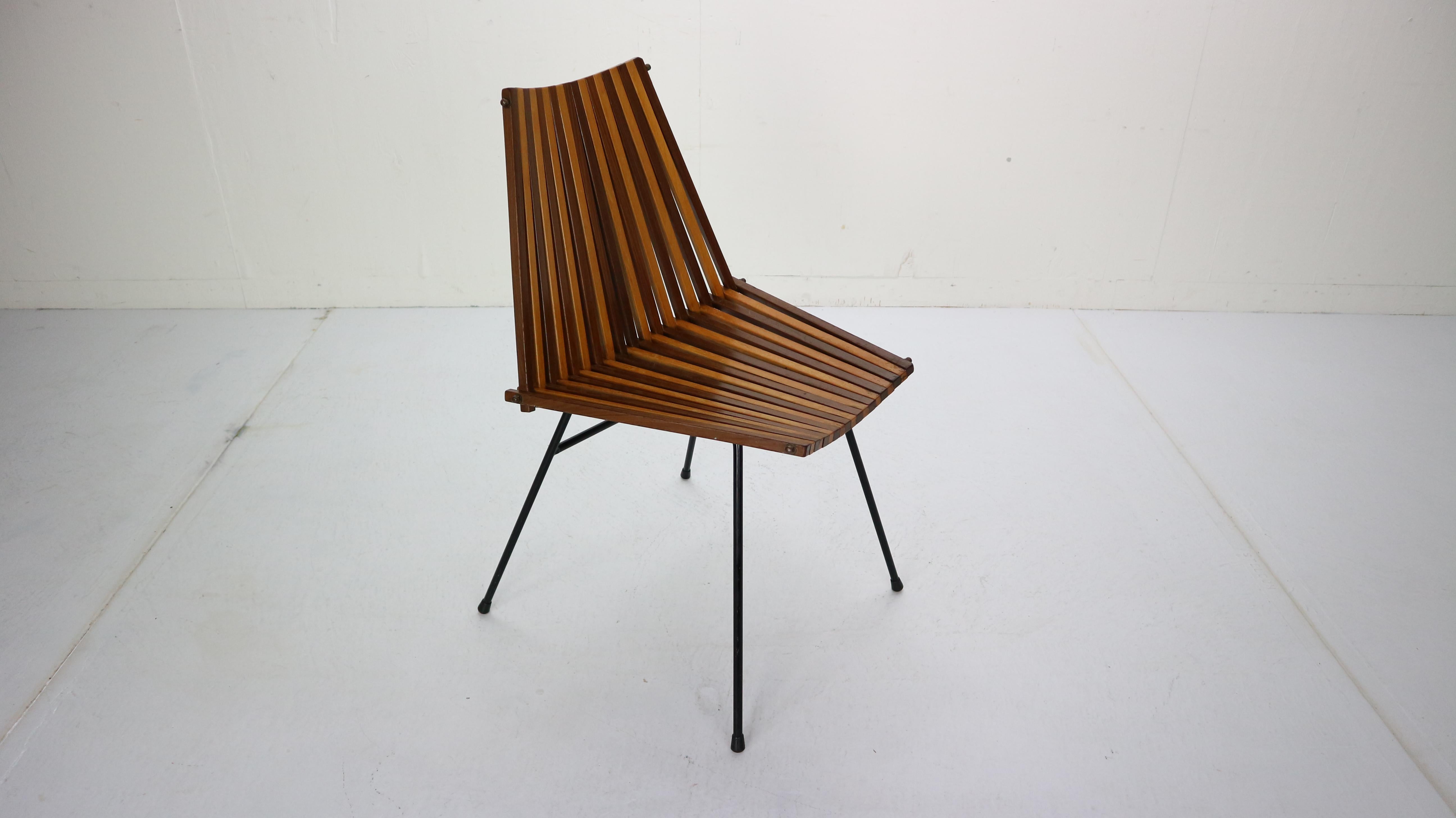 Elegant and special beautiful modernist chair, designed by Dirk van Sliedregt and made by Rohé Noordwolde in 1960s Netherlands.

This chair is made of steel rods with a back and seat, consists of 37 wooden slats in total. The slats are made of
