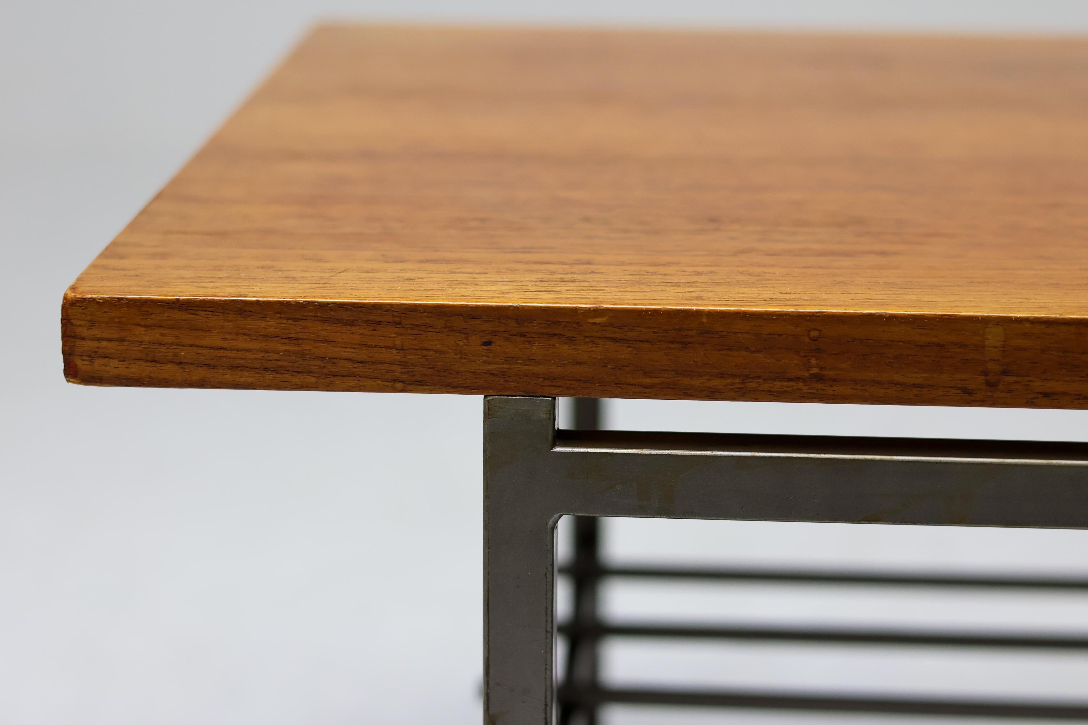 A refined example of Dutch modernist design from the 1950s, this coffee table combines architectural clarity with warm natural materials. The minimalist square steel rod base provides a light, linear structure that beautifully contrasts with the