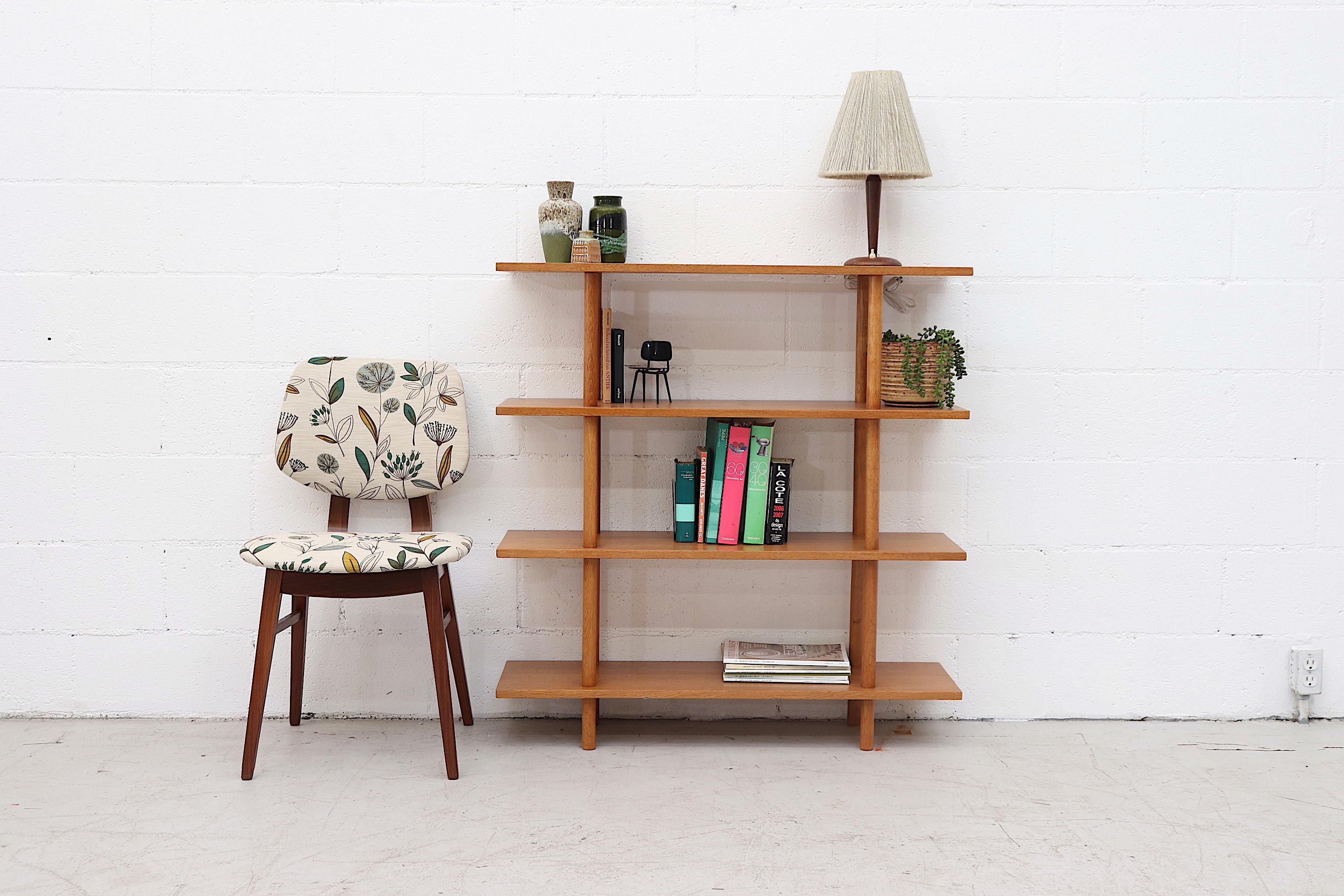 Simplistic single section four-level bookshelf. Lightly refinished in original condition with wear consistent with age and use.