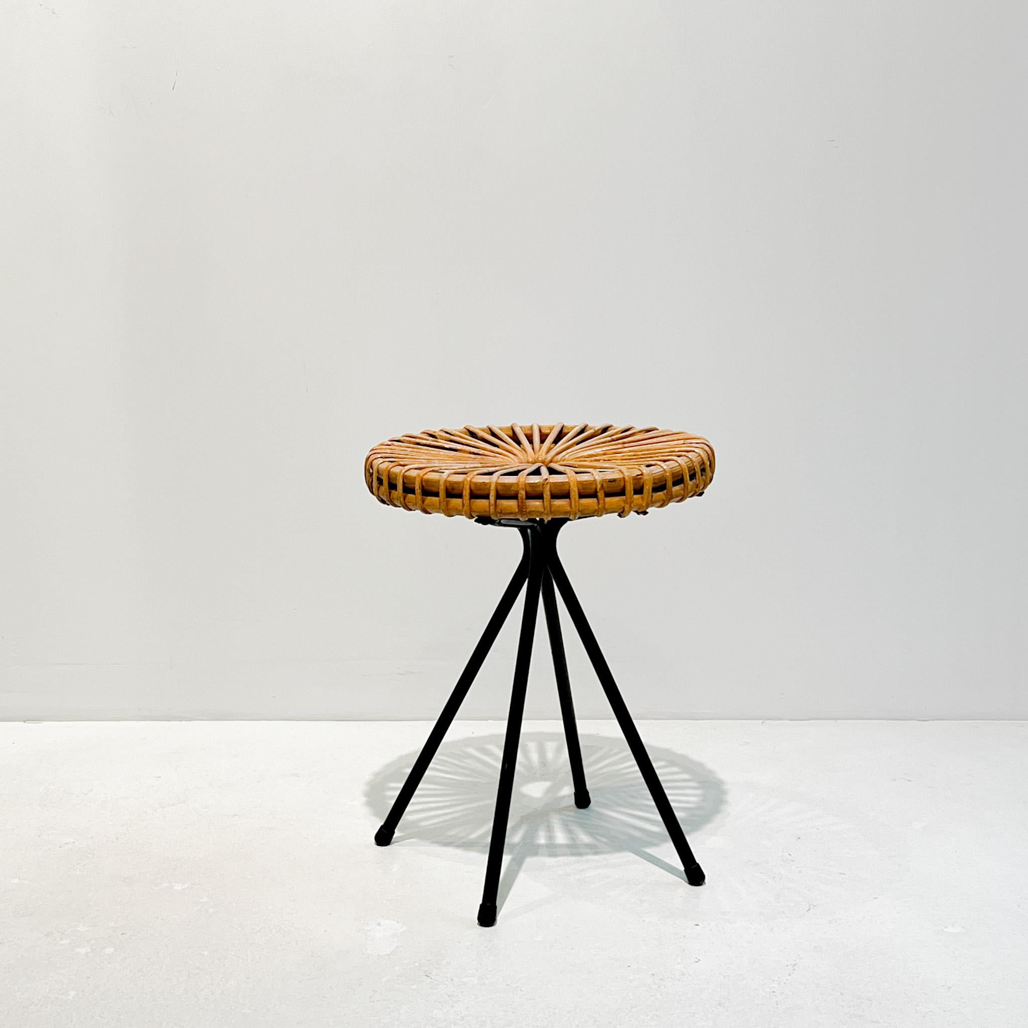 An elegant rattan stool designed by Dirk van Sliedrecht for Rohe Noordwolde, Holland, in the late 1950s. With a black lacquered metal base and a rattan seat.

'Dirk van Sliedregt (1920-2010) went from being a furniture maker to furniture designer