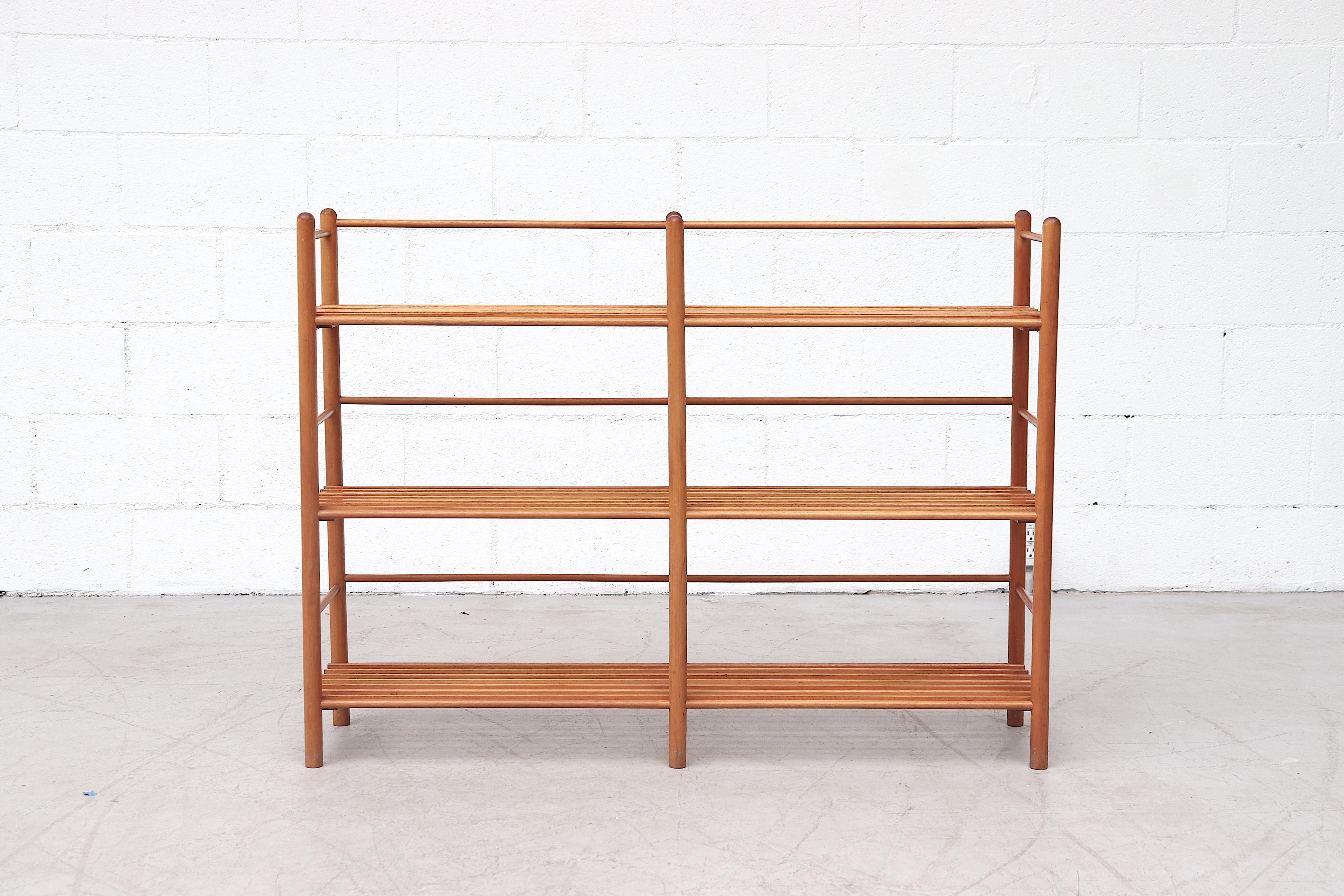 Simplistic double section three-level bookshelf with removable slat shelves. Lightly refinished in original condition with wear consistent with age and use.