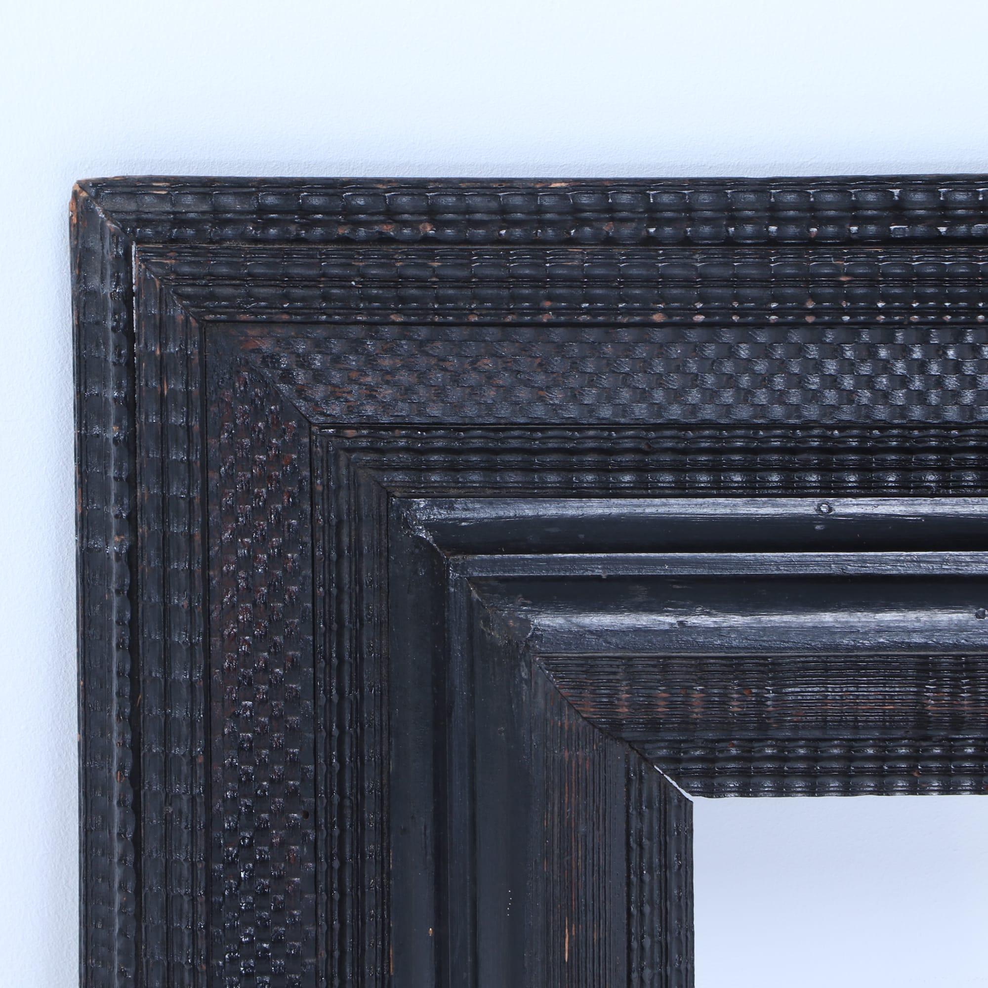 A carved and ebonized nineteenth century Dutch frame with ripple carvings. Interior dimensions 13.5 High, 9.5