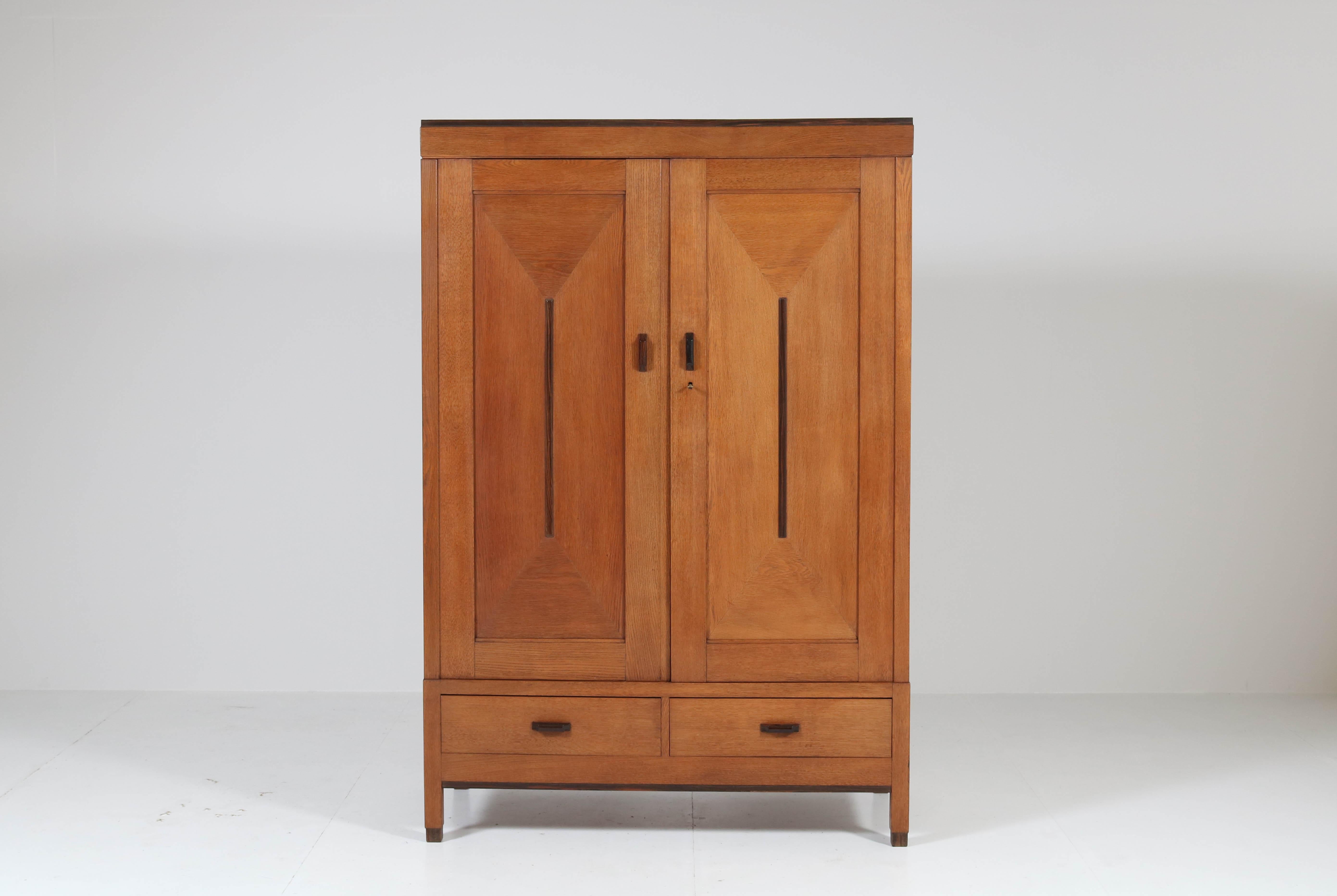 Offered by Amsterdam Modernism:
Stunning Art Deco Haagse school armoir or wardrobe.
Striking Dutch design from the 1920.
Solid oak with solid ebony Macassar handles on doors and drawers.
Both doors have oak veneer with solid ebony Macassar