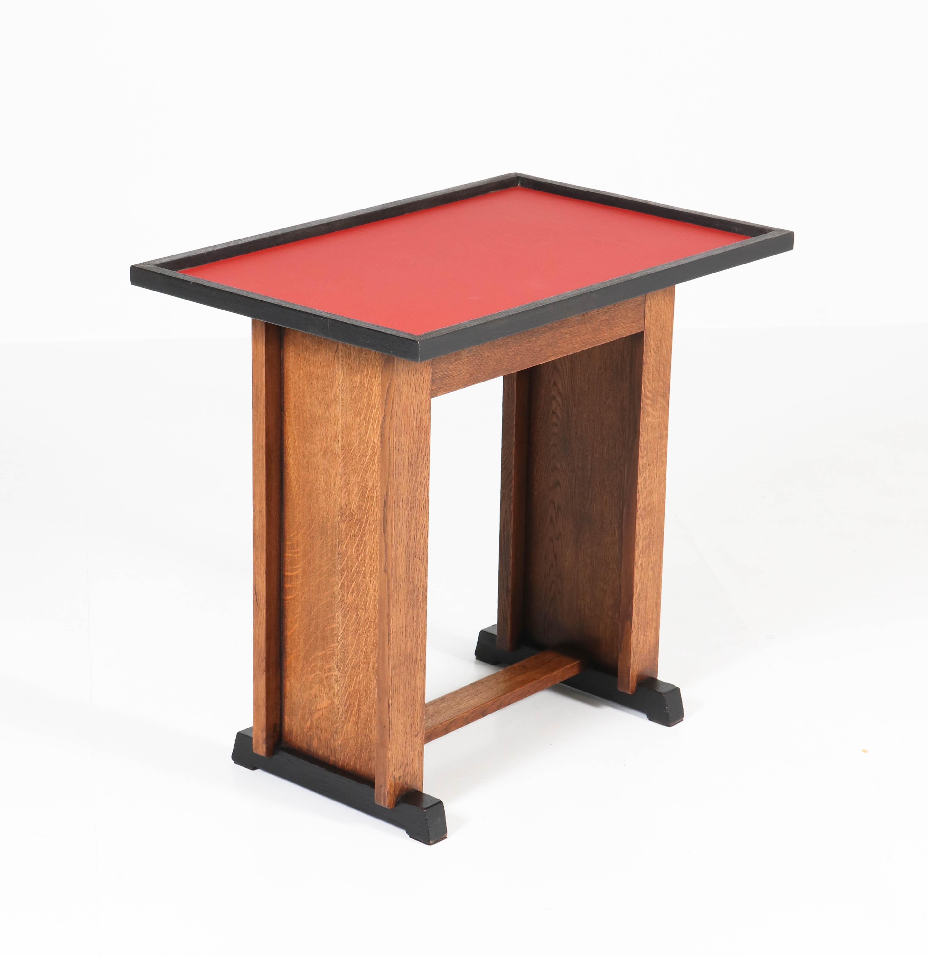Offered by Amsterdam Modernism:
Rare and stunning Art Deco Haagse School serving table.
Striking Dutch design by Jan Brunott from the 1920s.
Solid oak with red linoleum top.
Marked with original metal tag.
In good original condition with minor wear