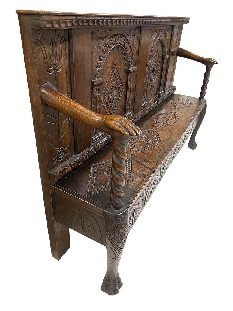 Dutch oak hall bench, 18th century

An oak hall bench with beautiful carvings in the shapes of arches on columns and with diamond patterns. 
Left and right of the back of the bench with a scene of a tulip flower with a tulip bulb. 
The armrests in