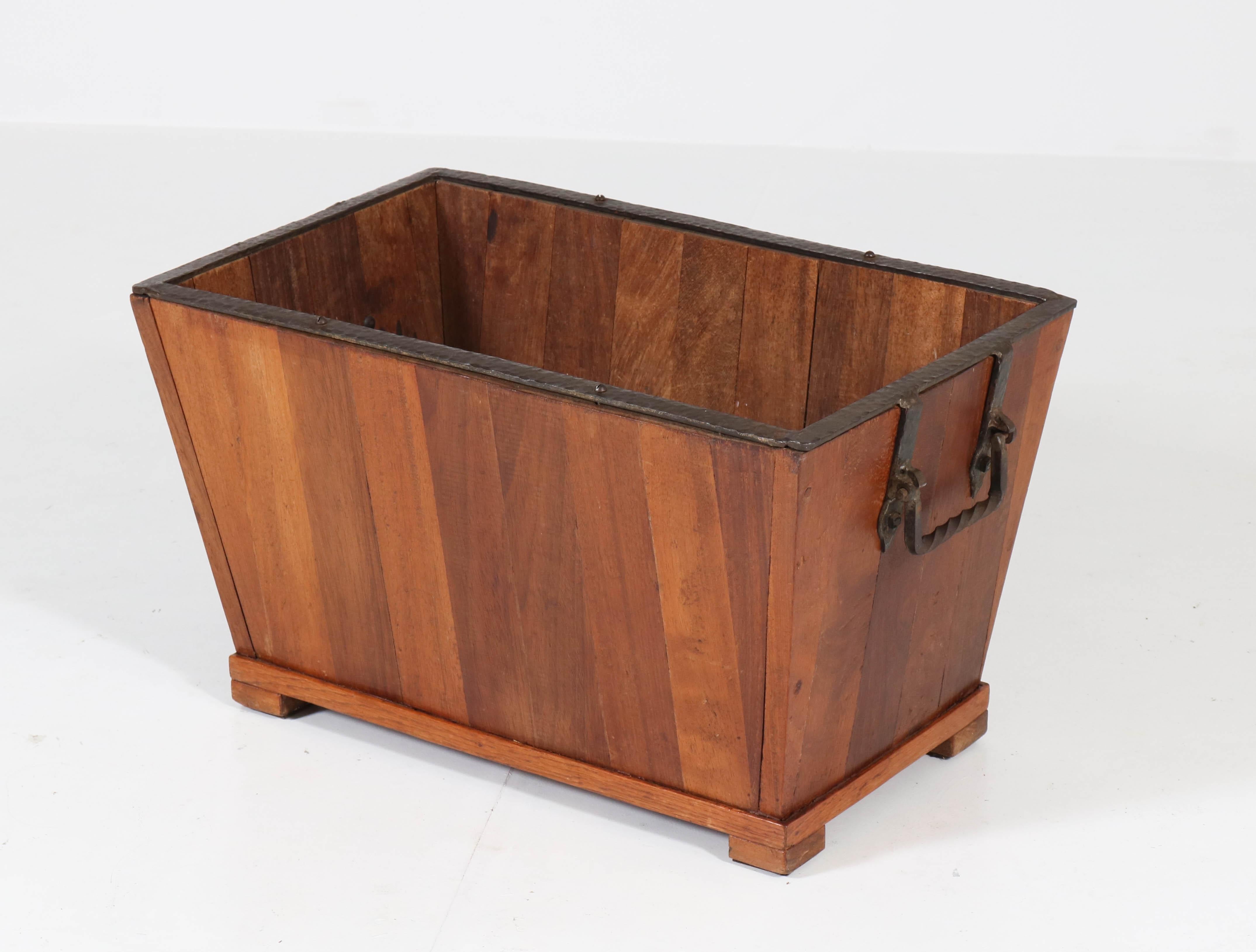 Stunning and rare Mid-Century Modern firewood box.
Solid padouk with original wrought iron lining and handles.
Striking Dutch design from the 1950s.
In good original condition with minor wear consistent with age and use,
preserving a beautiful