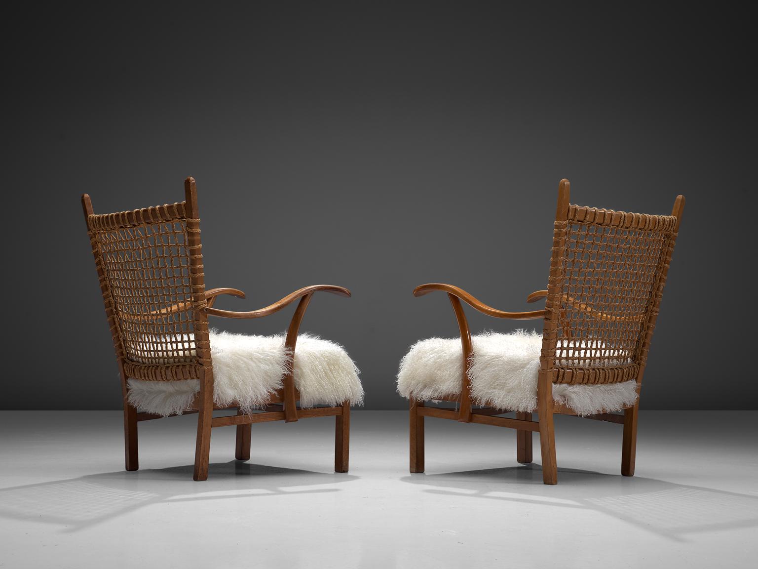 Dutch set of 2 armchair, oak, cane, Tibetan wool, the Netherlands, 1940s.

This robust Dutch chair originates from the late 1940s. The seat is make of oak and back is made of woven cane.. This natural, robust style is typical for design of the
