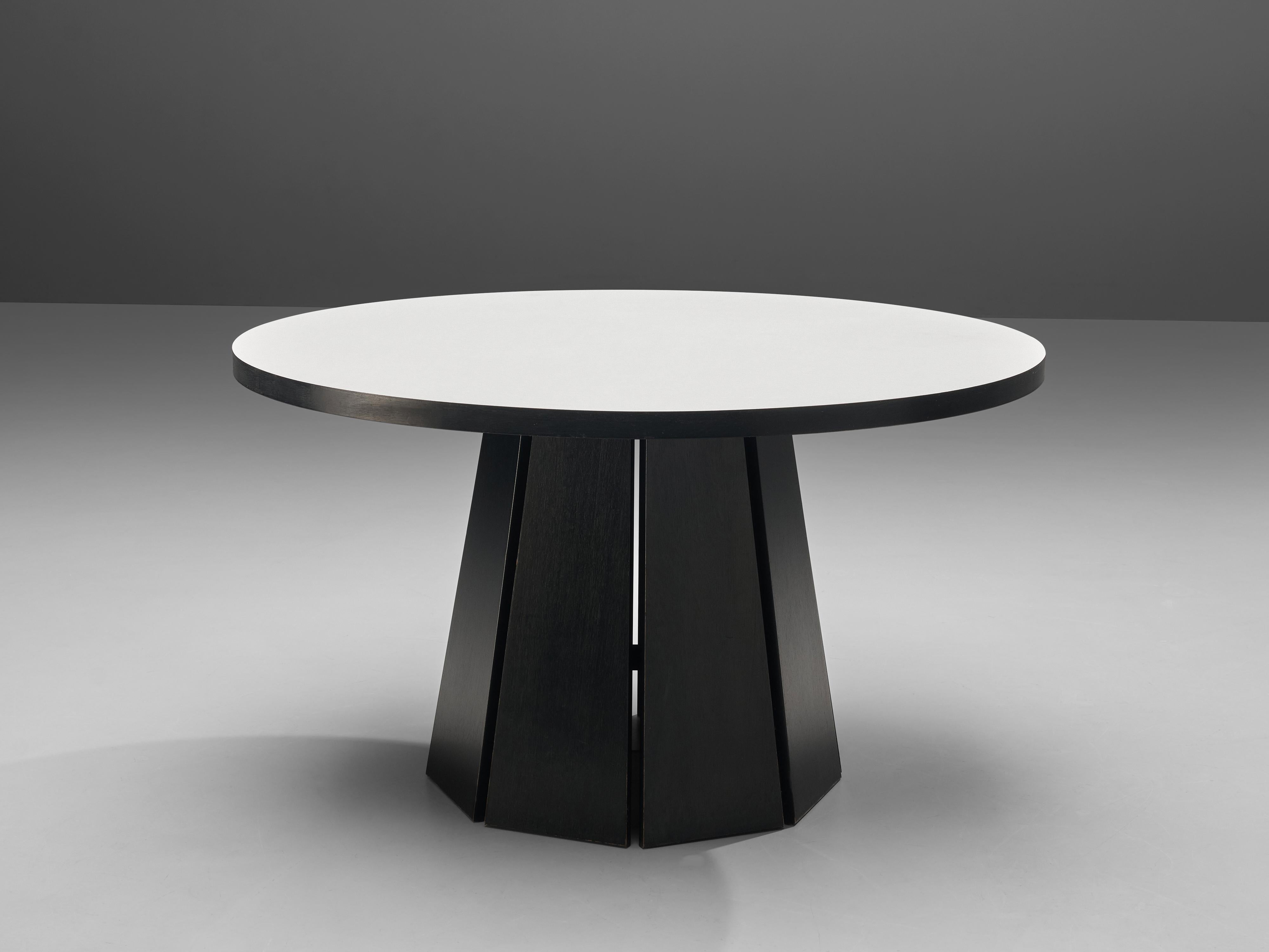 Dining or center table, black and white lacquered wood, The Netherlands, 1970s

Crafted by Pastoe, this geometric table stands as a testament to modern design sensibilities. This pedestal dining table features a round tabletop. The base is made out