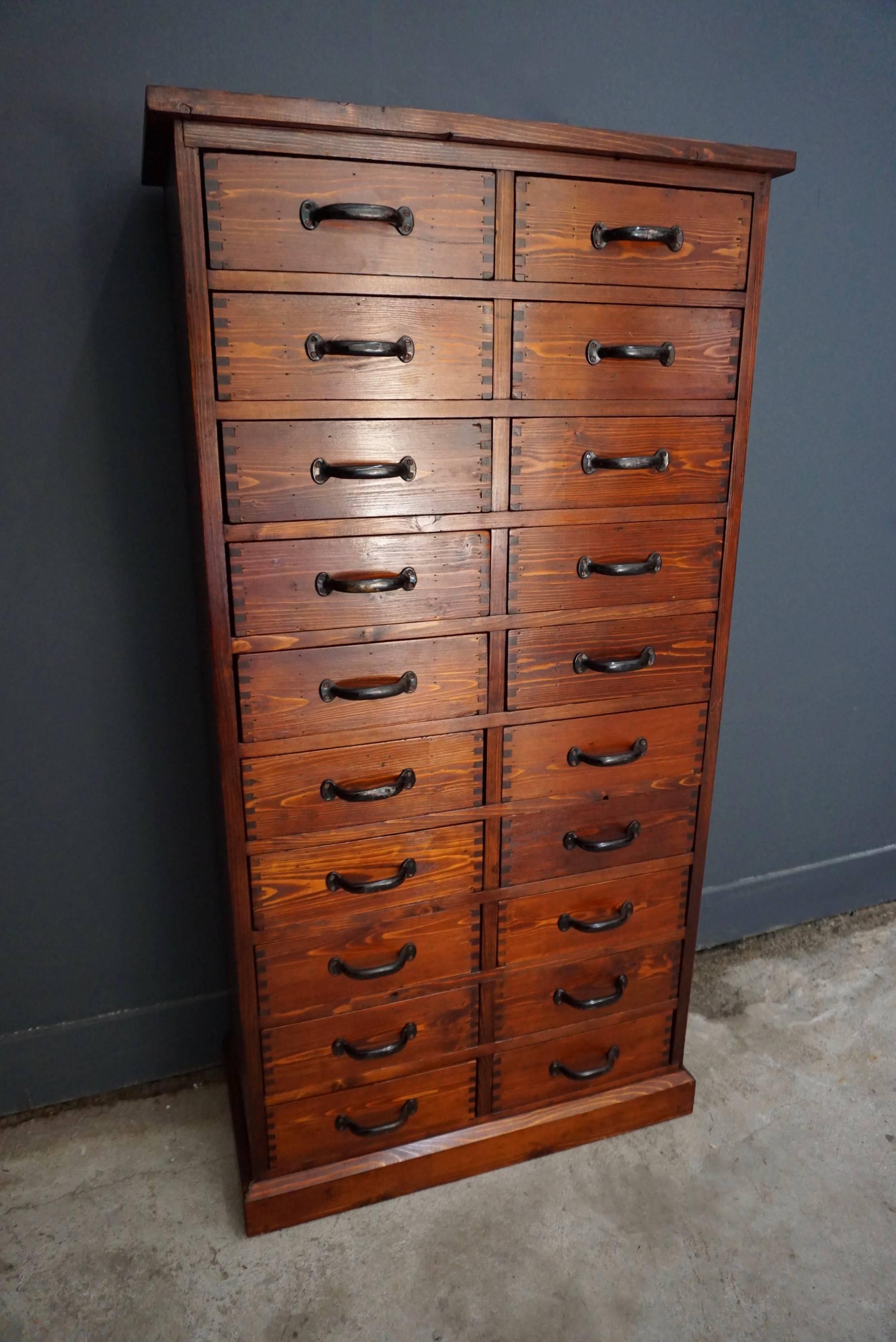This pine apothecary cabinet was designed and made, circa 1950 in The Netherlands. It features drawers with metal hardware. The inside of the drawers measure: 30 x 29.5 x 9.5 cm.