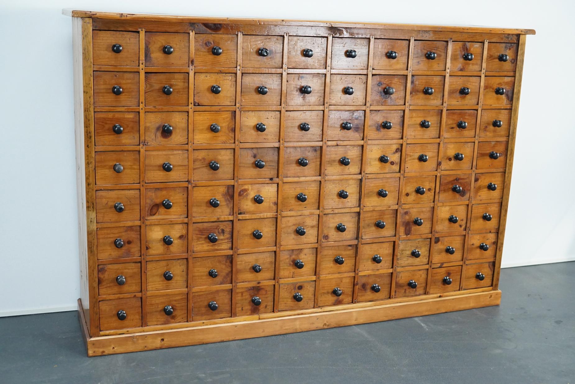 This apothecary cabinet was designed during the 1940s in The Netherlands. The piece features 80 drawers with iron hardware. It remains in a very good restored condition with signs of use and age.

The inside measurements of the drawers are: L 32 x