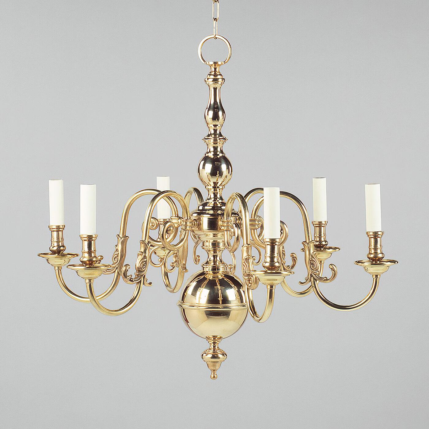 This chandelier is inspired by a dutch antique. The central stem comprised of brass spheres complements the leaf-like decoration on the upward-curving arms.

The chandelier is fabricated and soldered using solid cast brass components, ensuring the